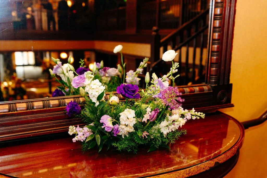 Large arrangement in purple and white at cocktail hour, florals by Hydrangea Bloom, photographed by Christina Ney Photography