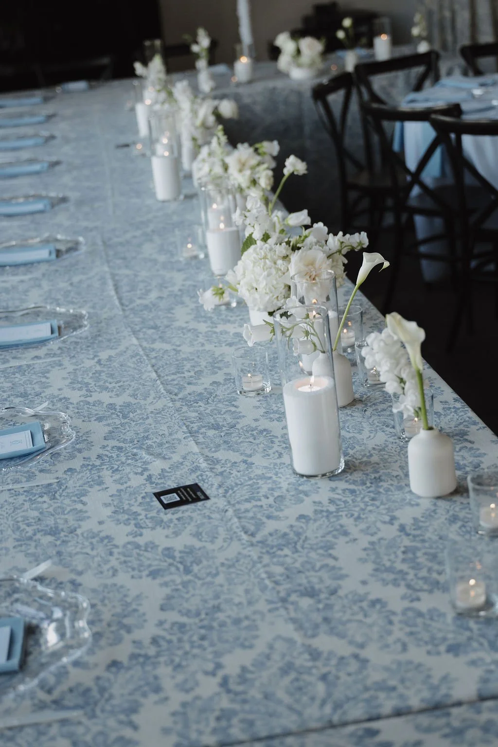 White bud vases and candles down a long table, florals by Hydrangea Bloom, photographed by Shelby Sawyer Photography