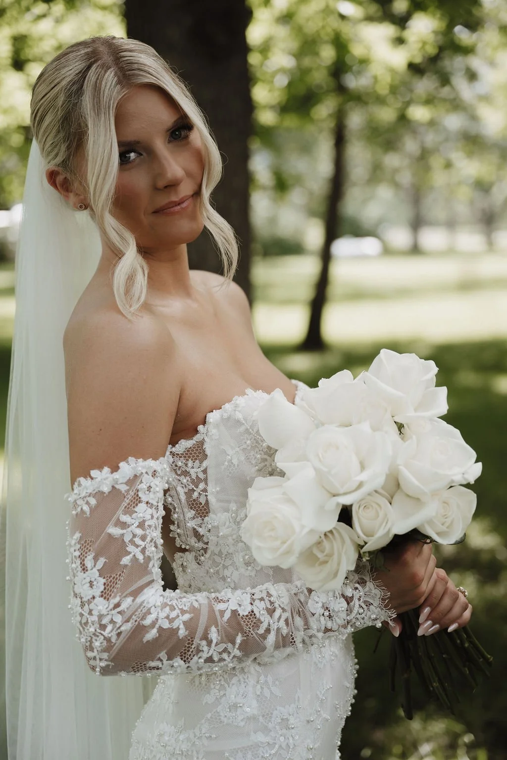 Bride holding her white rose bouquet, florals by Hydrangea Bloom, photographed by Shelby Sawyer Photography