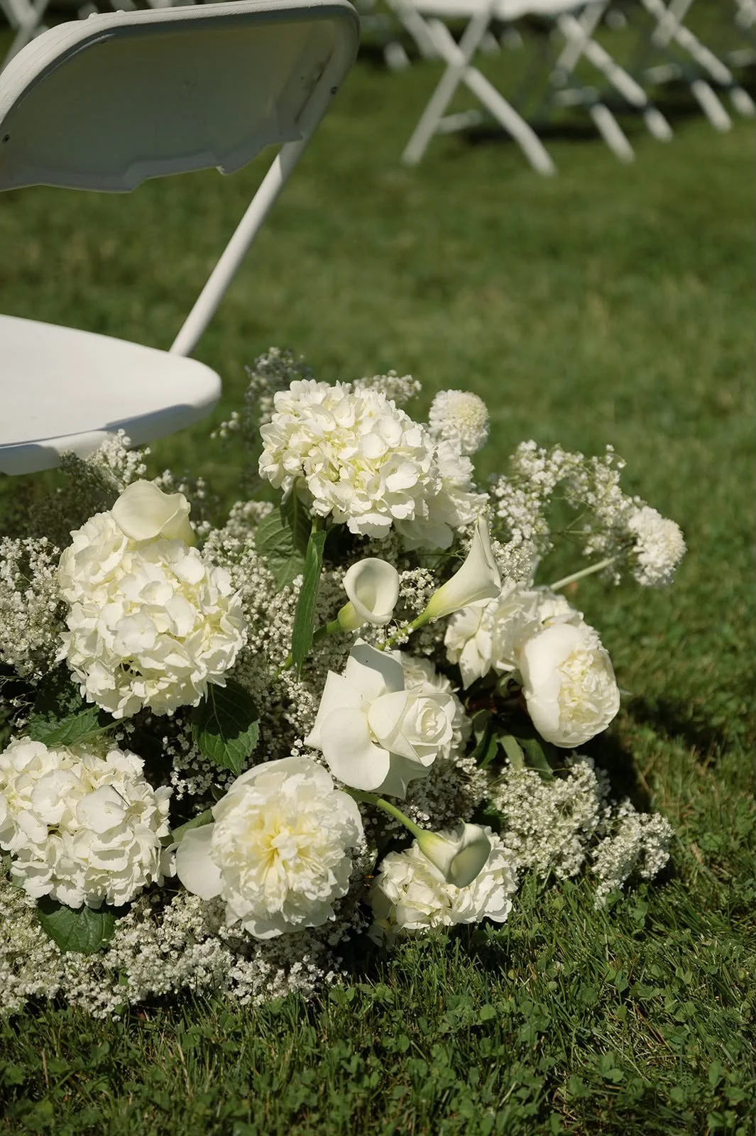 White hydrangea and rose arrangement at the aisle, florals by Hydrangea Bloom, photographed by Hayley Dolson Photography