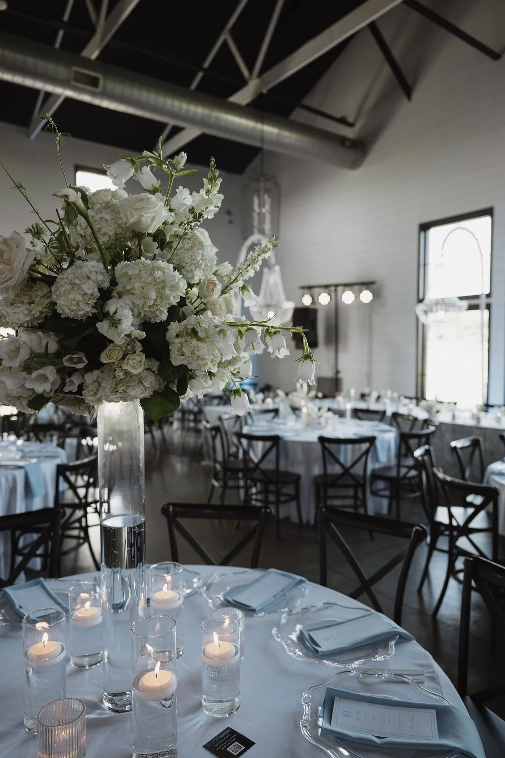Tall centerpieces across the reception room, florals by Hydrangea Bloom, photographed by Shelby Sawyer Photography