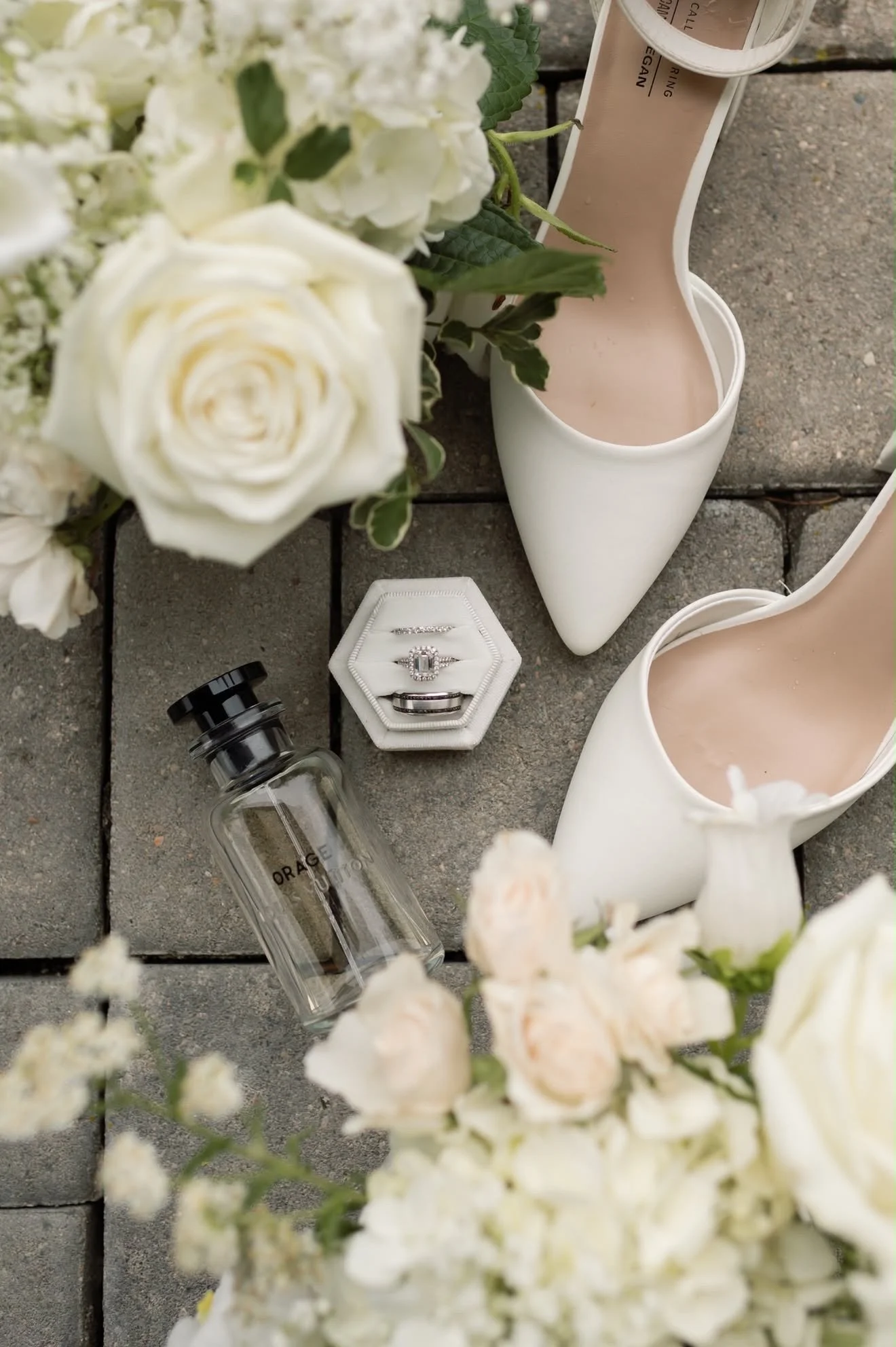 Rings, shoes and white roses arranged as a flat lay, florals by Hydrangea Bloom, photographed by Hayley Dolson Photography