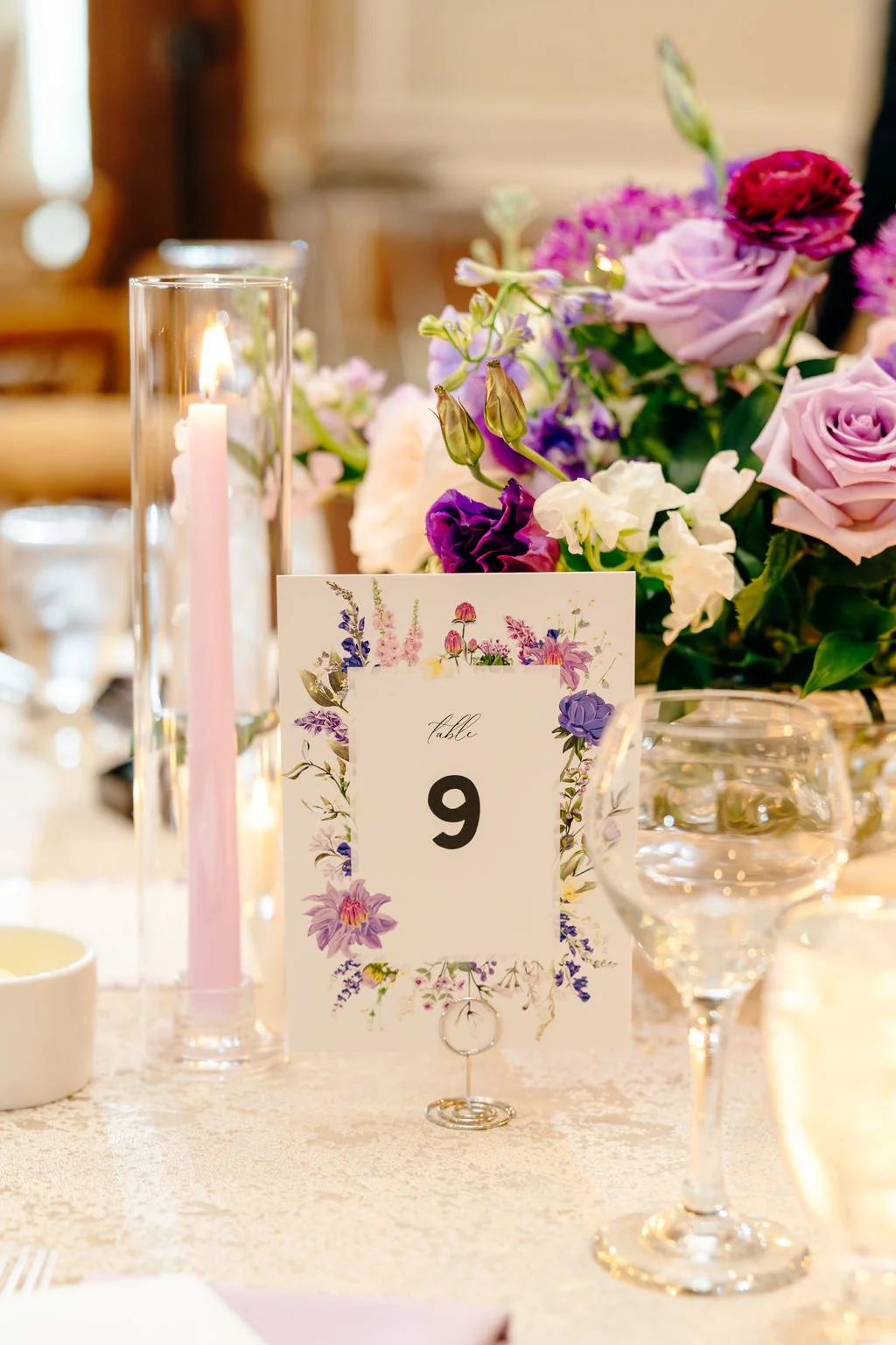 Reception centerpiece beside the table number, florals by Hydrangea Bloom, photographed by Christina Ney Photography