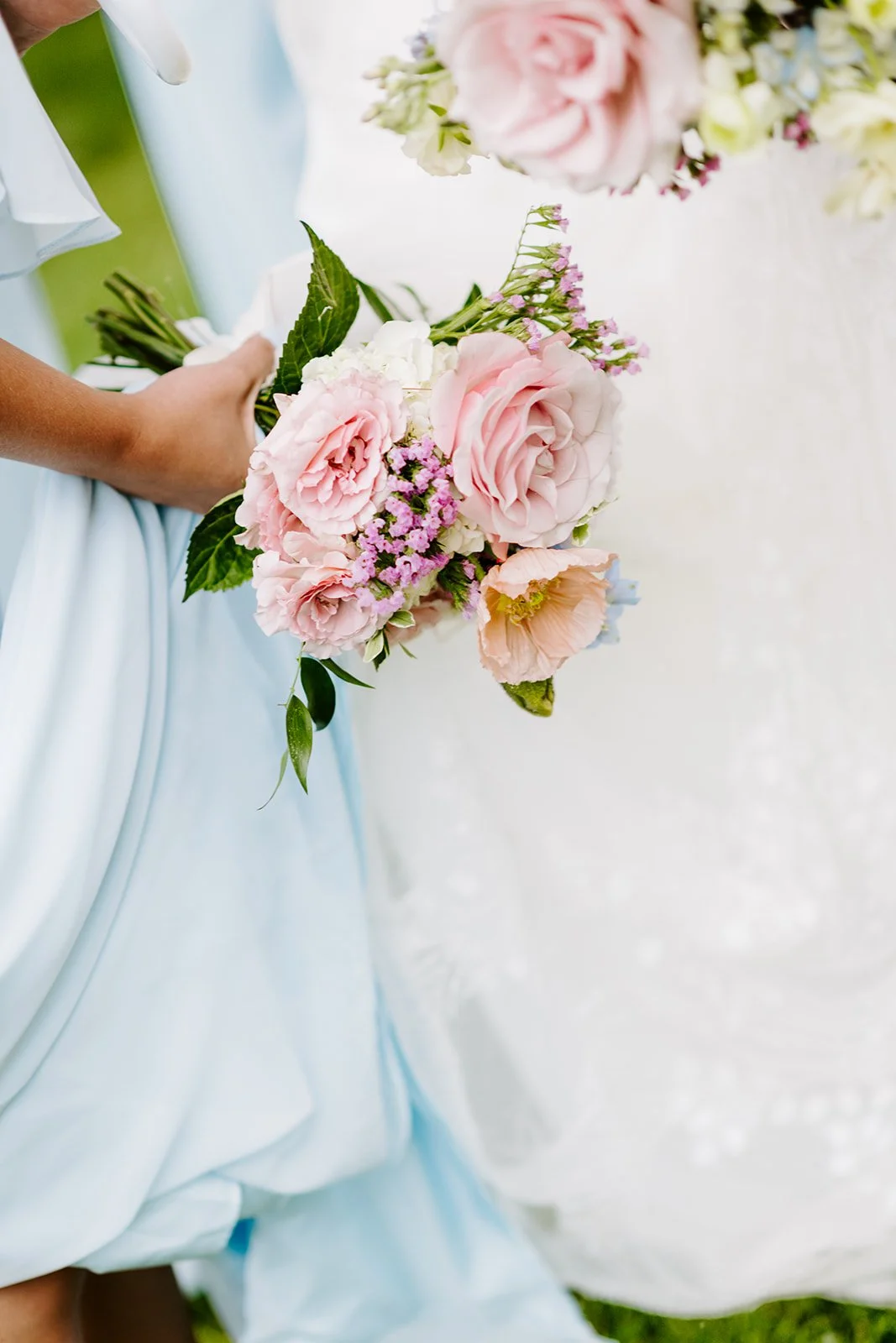 Bridal bouquet held against the gown, florals by Hydrangea Bloom, photographed by Karly Ellis Photography
