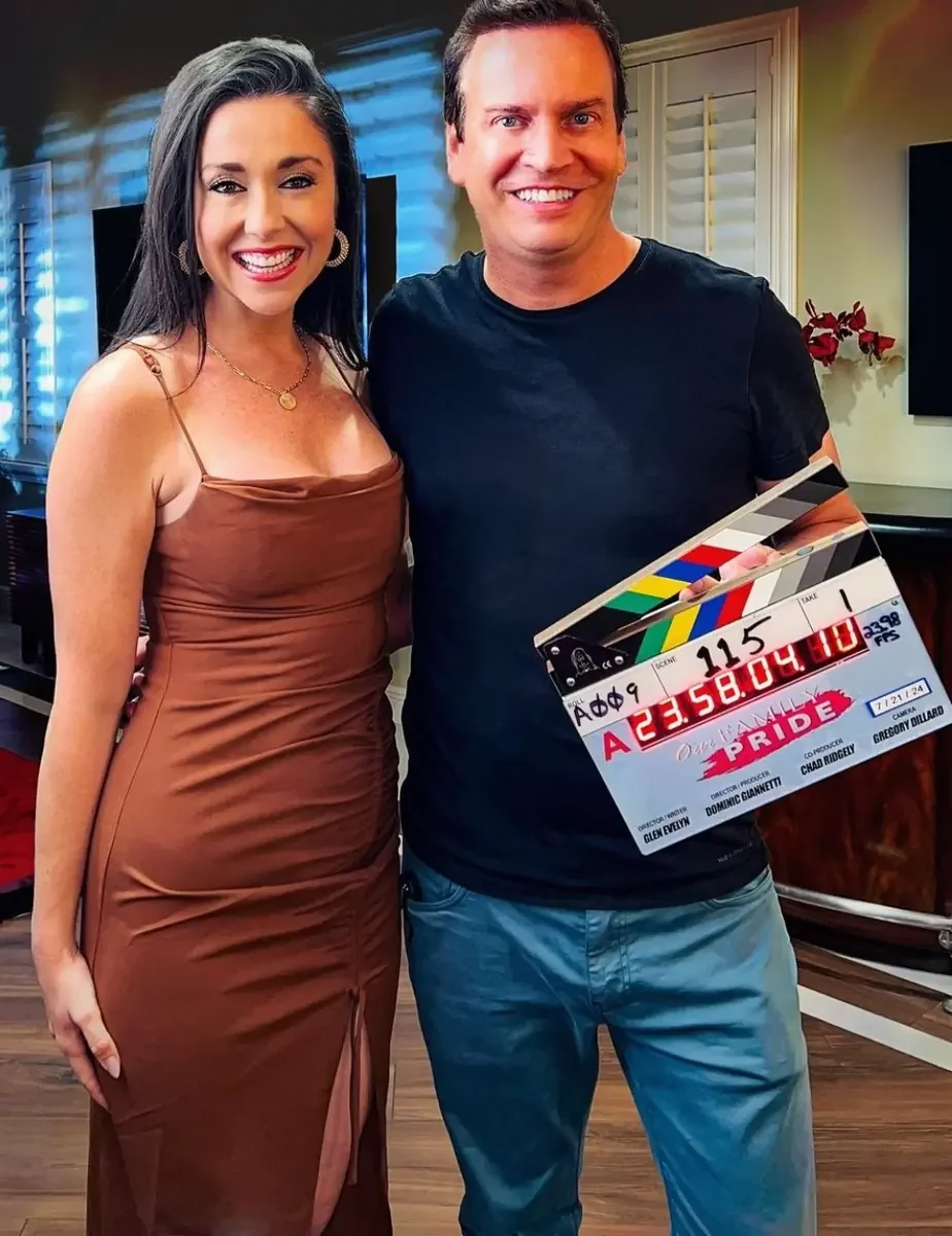 Cast member holding the Our Family Pride clapperboard