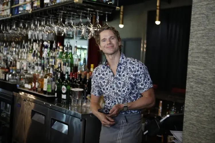Cast member behind the bar on set
