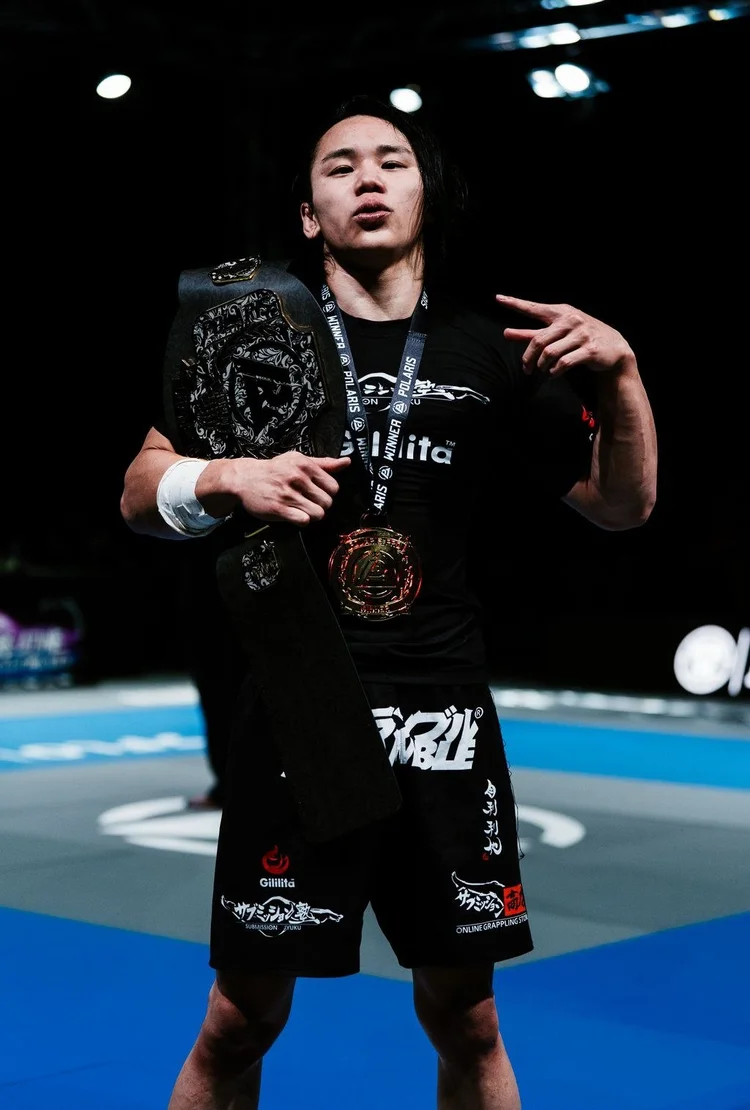 Yuki Takahashi holding the Polaris bantamweight belt and winner's medal