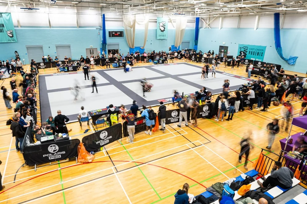 Polaris PSG competitors and crowd around the mats at a packed London sports hall