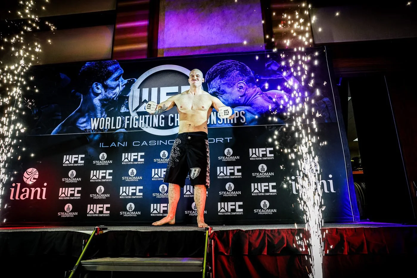 Fighter entrance with sparks in front of the WFC banner