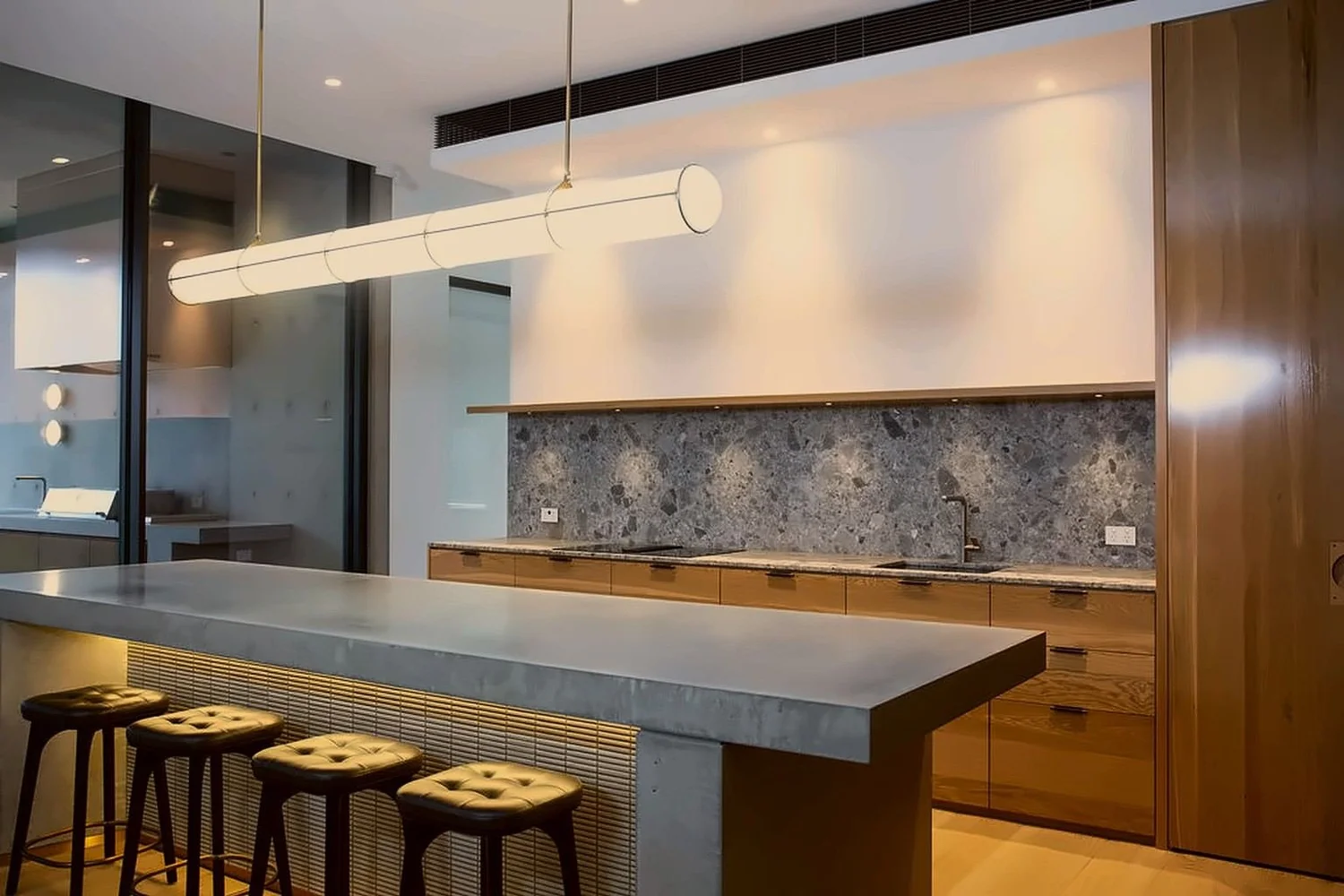 Kitchen with concrete island, terrazzo splashback and oak joinery in a private Sydney home