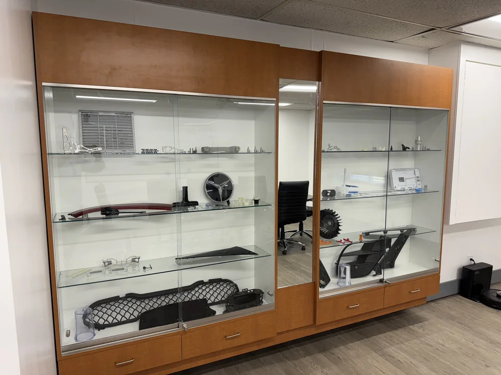 Lobby display case of machined and molded parts made by UTP Solutions