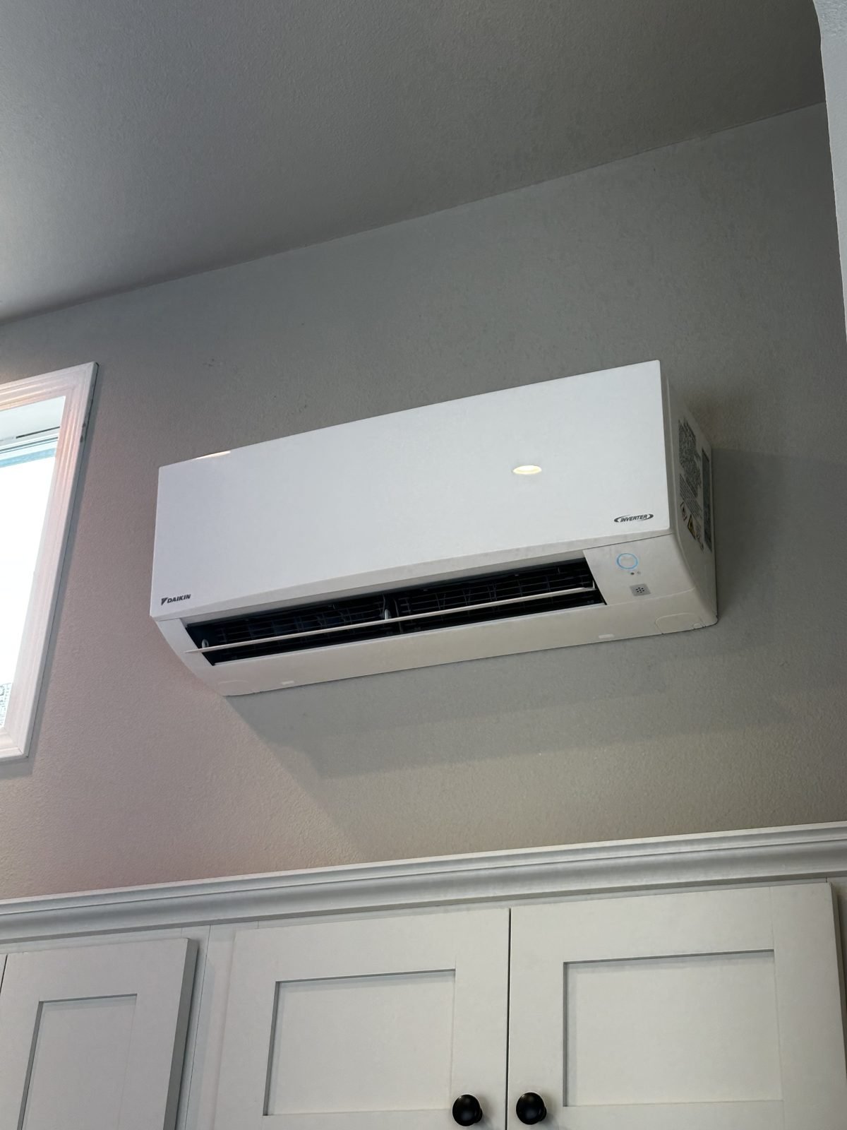 Daikin inverter mini split indoor head unit mounted high on the wall of a park model tiny home