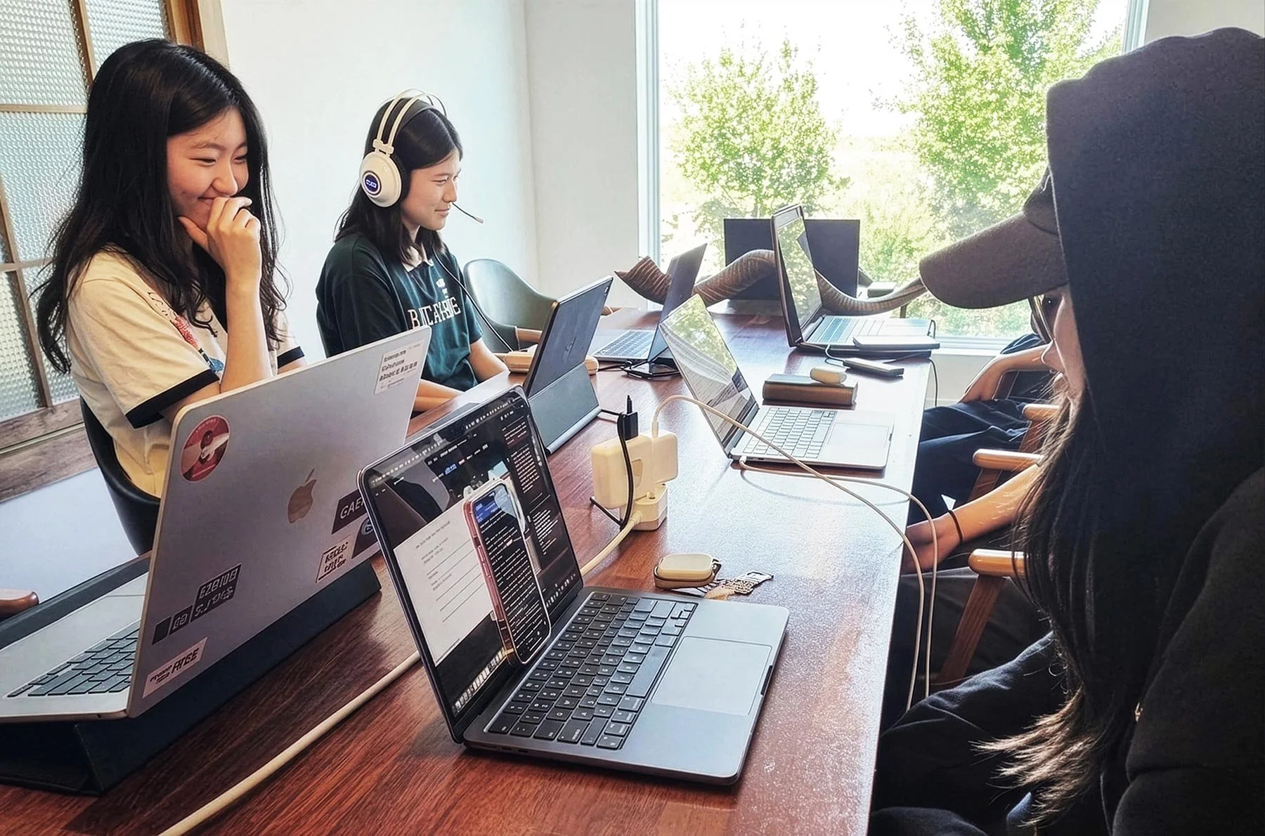 Students collaborating at laptops