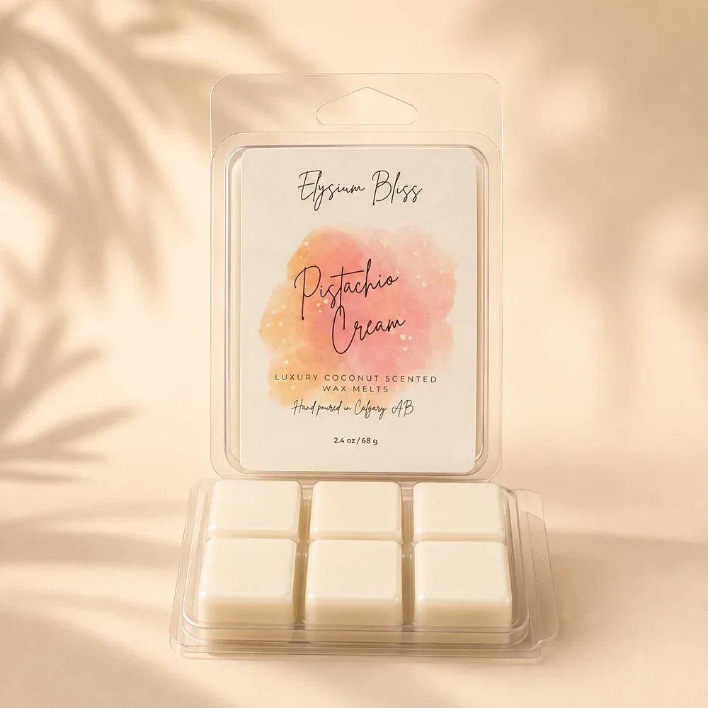 Open clamshell of Elysium Bliss Pistachio Cream coconut wax melts showing six cream-coloured cubes, on a warm cream background with soft palm-frond shadow.