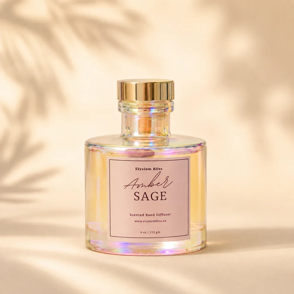 Elysium Bliss Amber Sage scented reed diffuser — iridescent glass bottle with iridescent cap and mauve label on a warm cream background with soft palm-frond shadow.