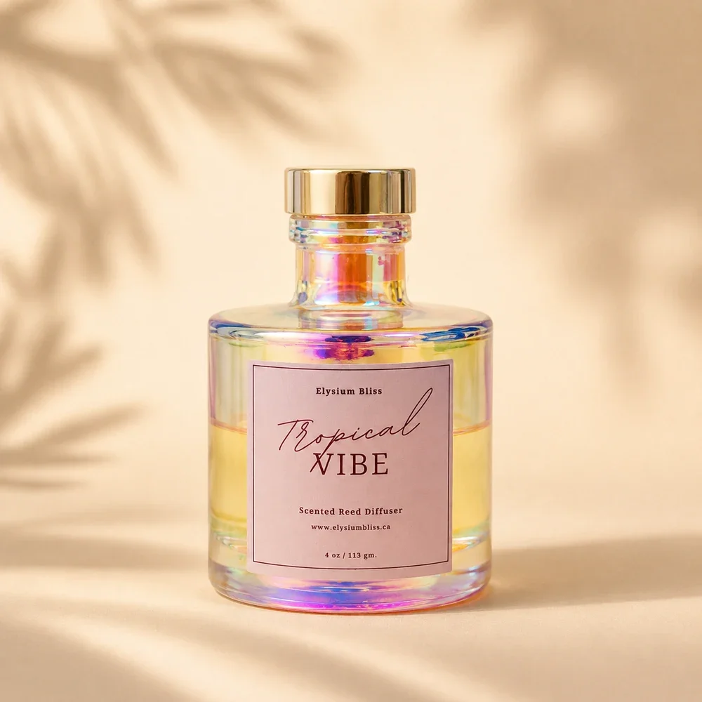 Elysium Bliss Tropical Vibe scented reed diffuser — iridescent glass bottle with iridescent cap and mauve label on a warm cream background with soft palm-frond shadow.