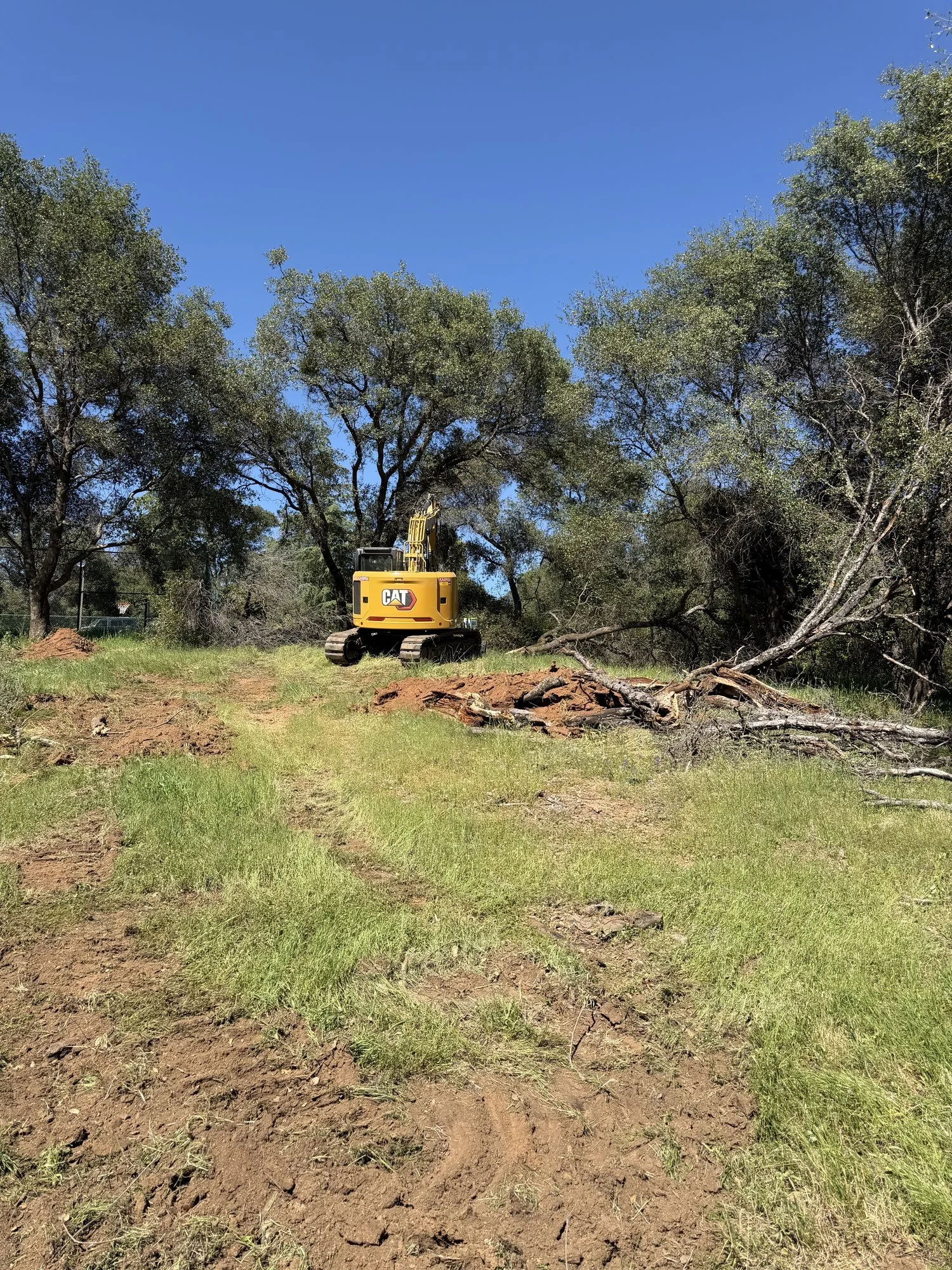 Dozer and excavator moving dirt on the shop pad site in Newcastle, CA