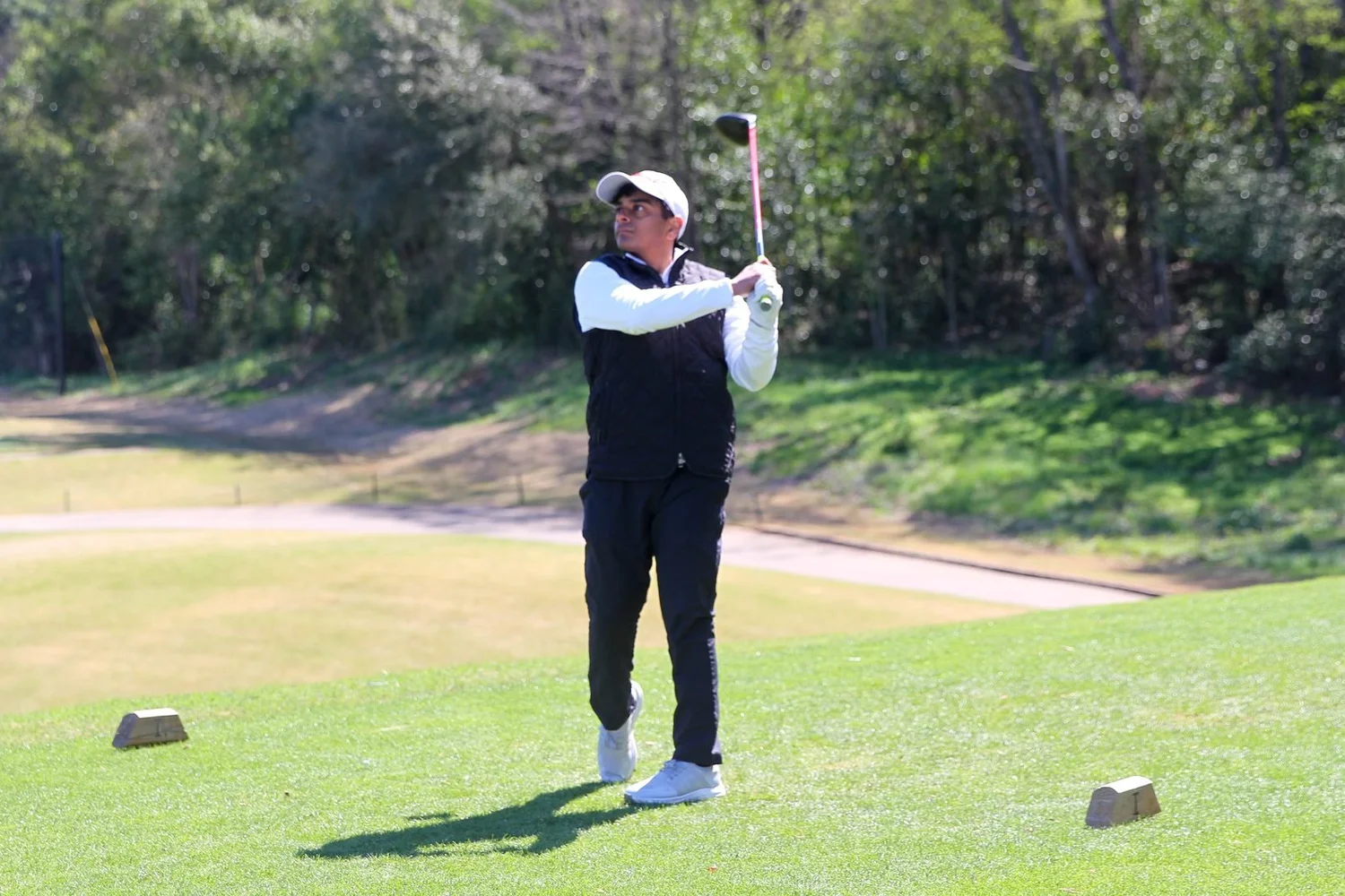 Golfer watching his tee shot