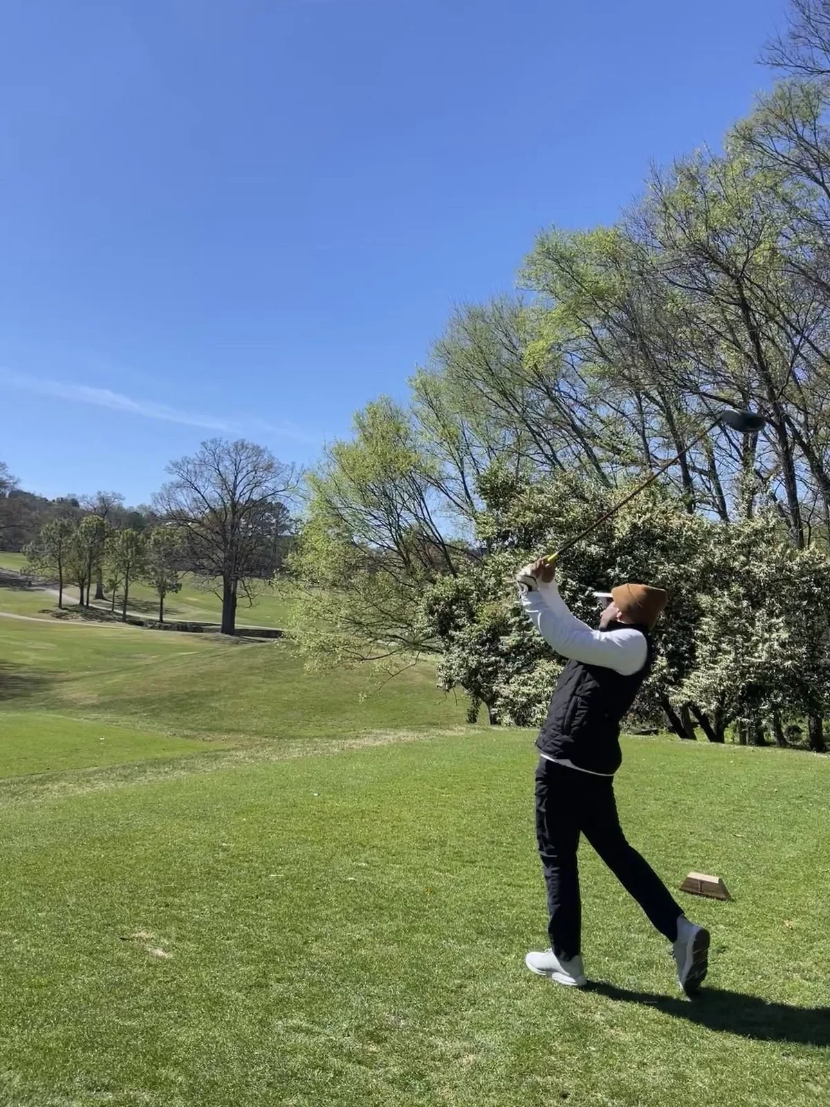 Golfer swinging away on a sunny tee box