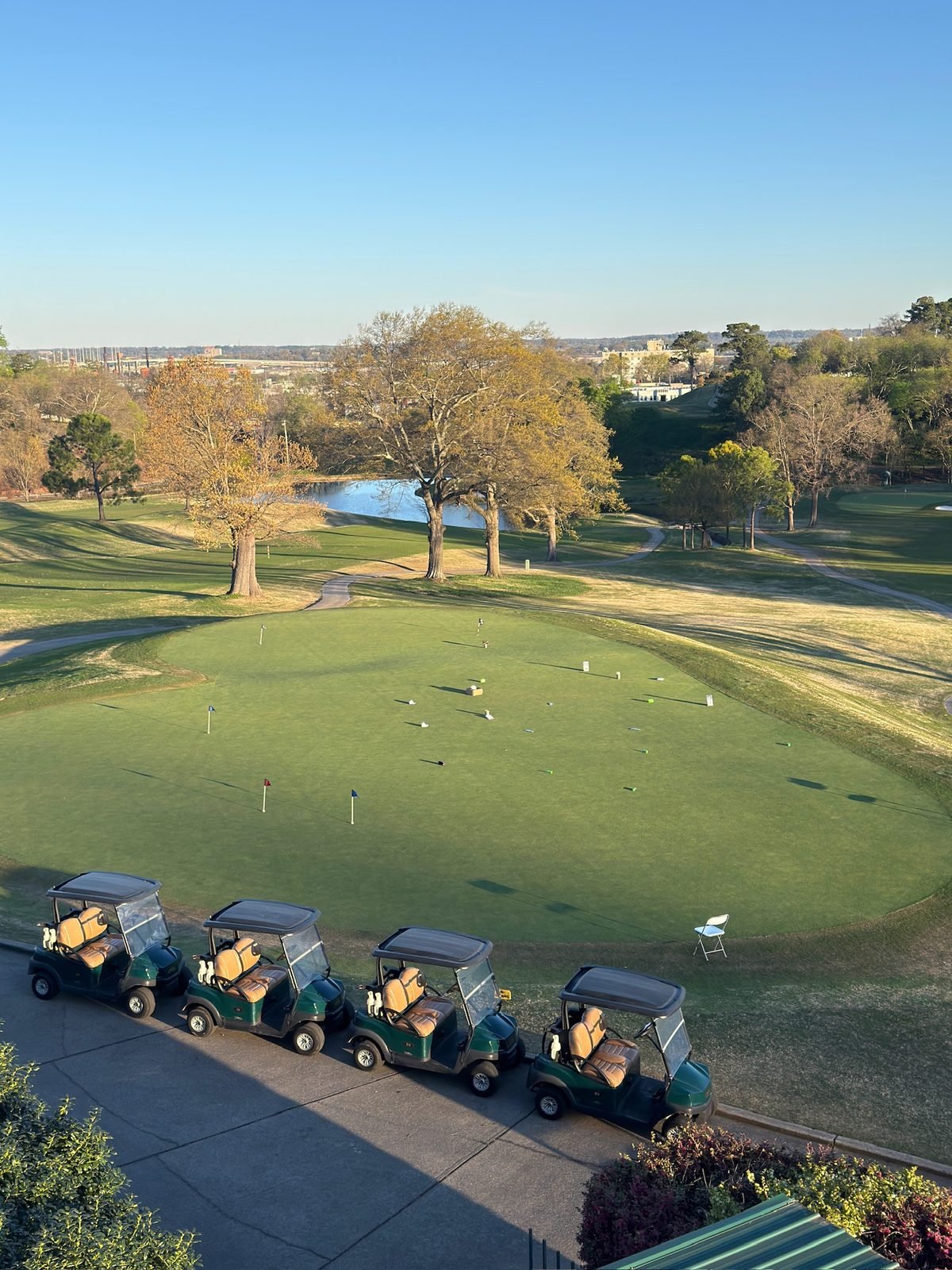 Golf carts lined up above the putting green at Highland Park