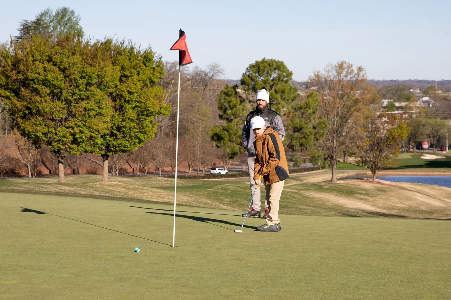 A young golfer lining up a putt