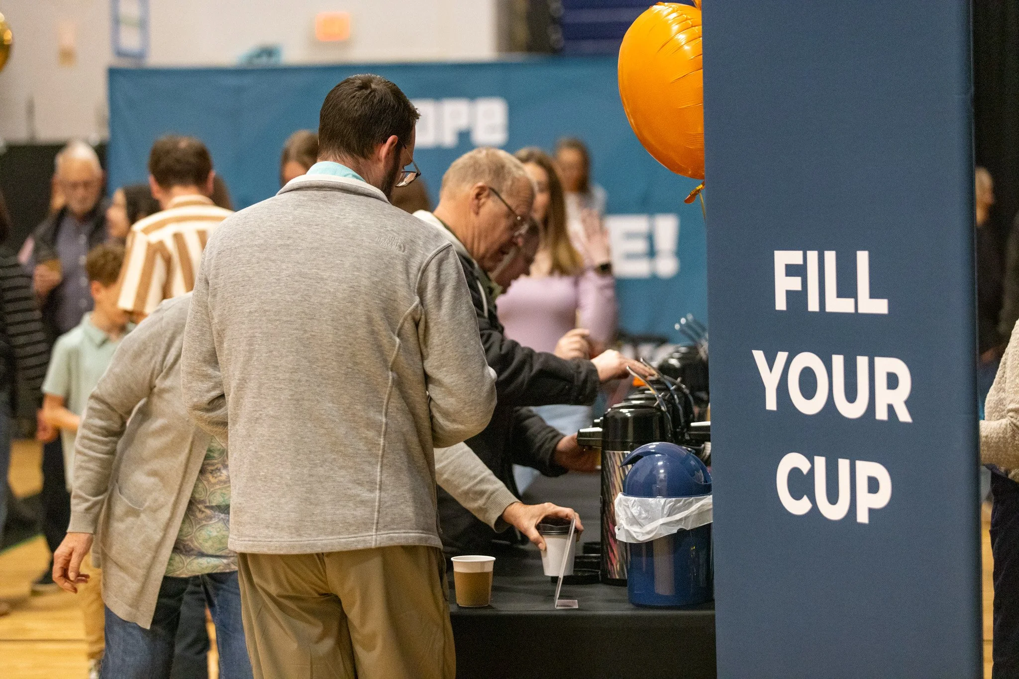 People chatting over coffee in the lobby