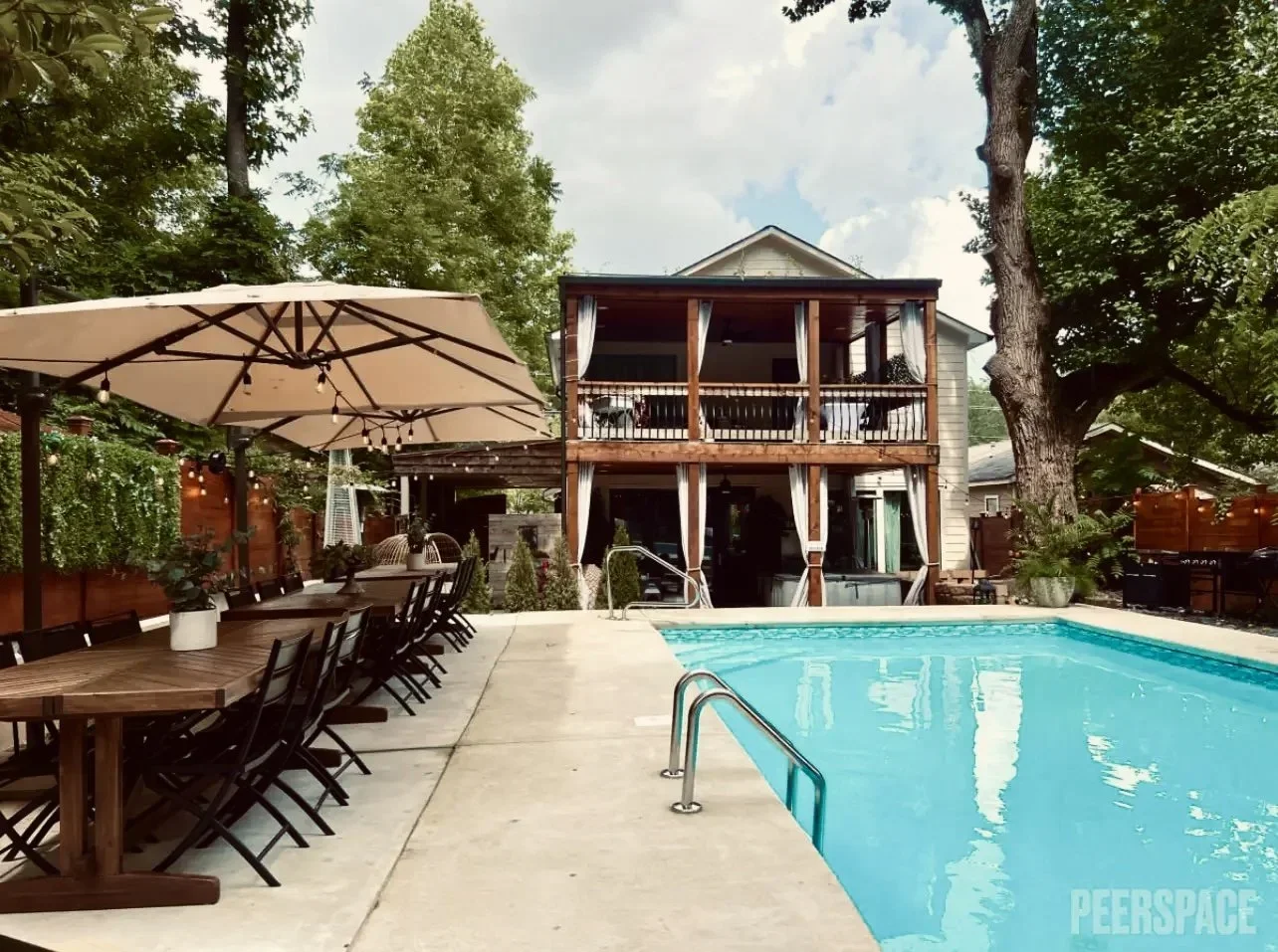 Hill House and pool, long dining table set for a daytime gathering