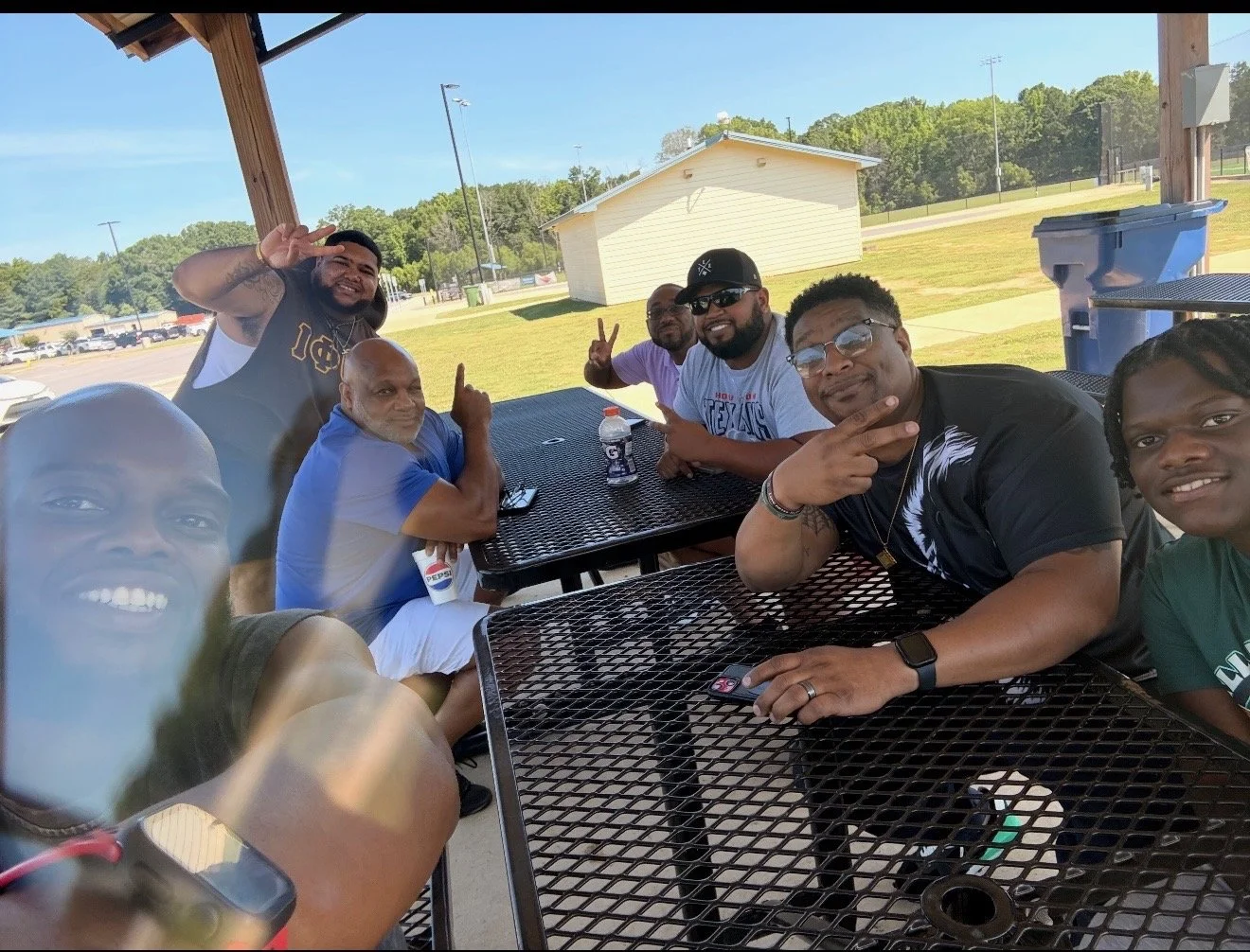 Men's life group meeting outdoors at a park pavilion
