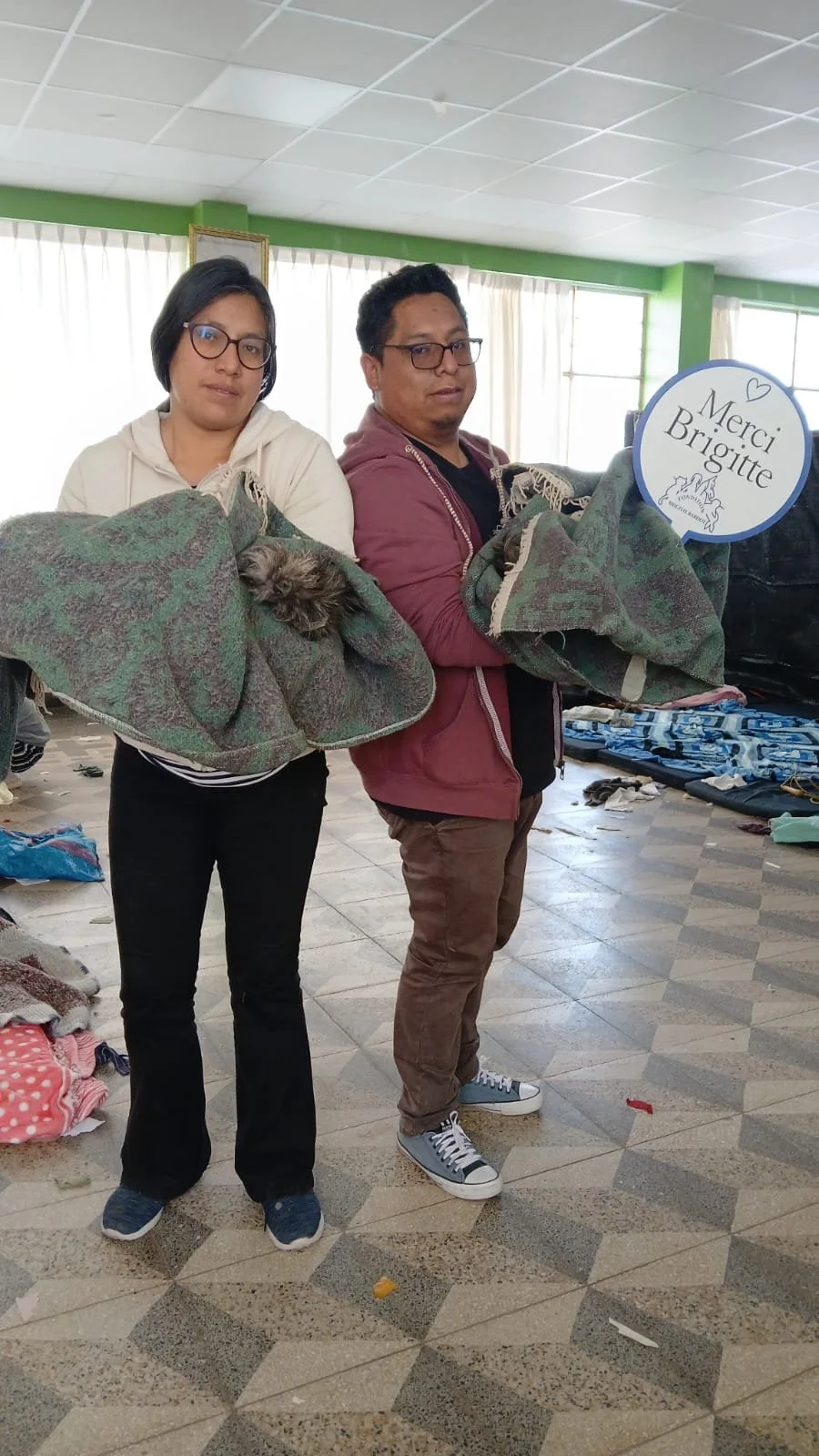 Two people holding recovering animals