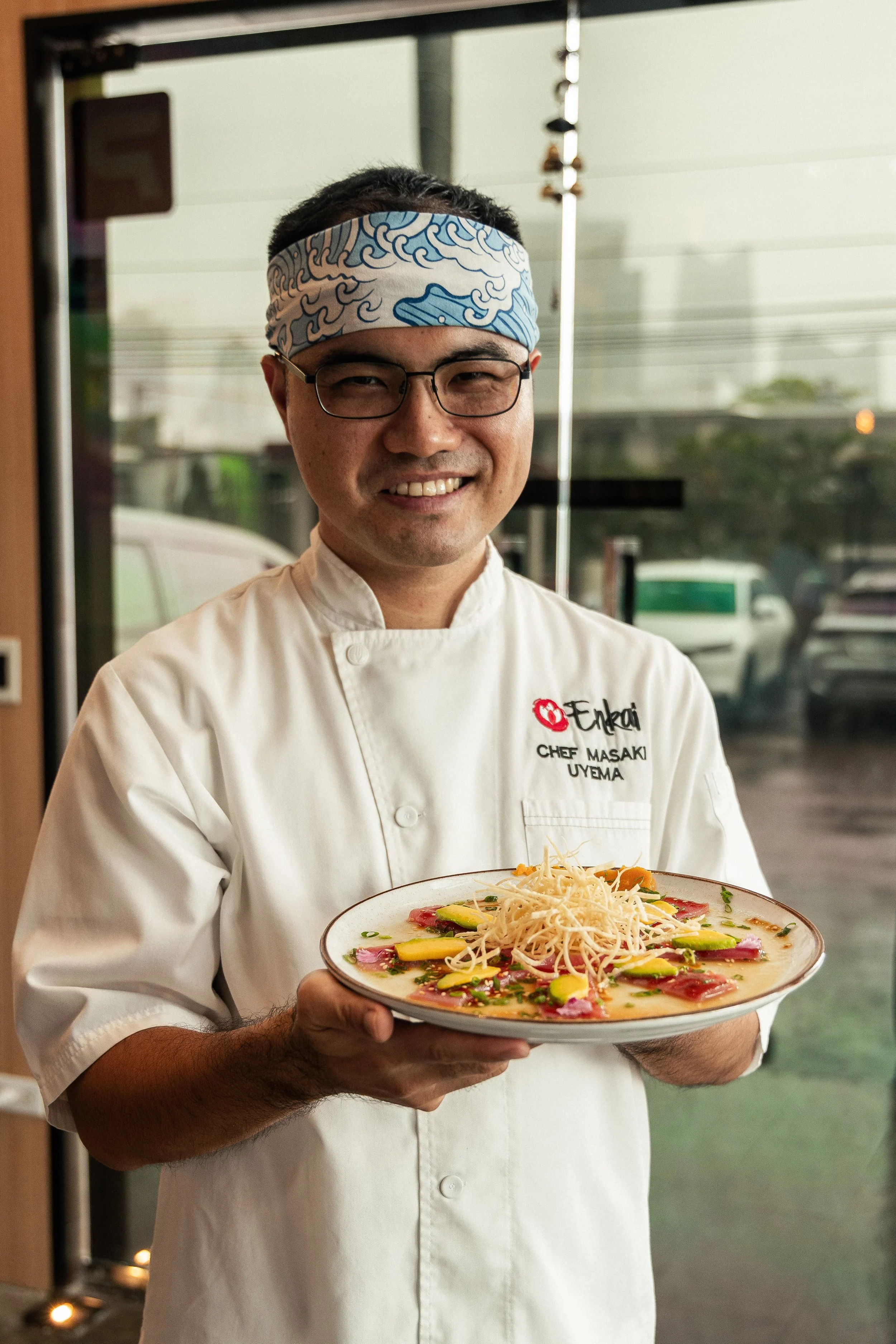 Chef Masaki Uyema presenting a Nikkei dish at Enkai.