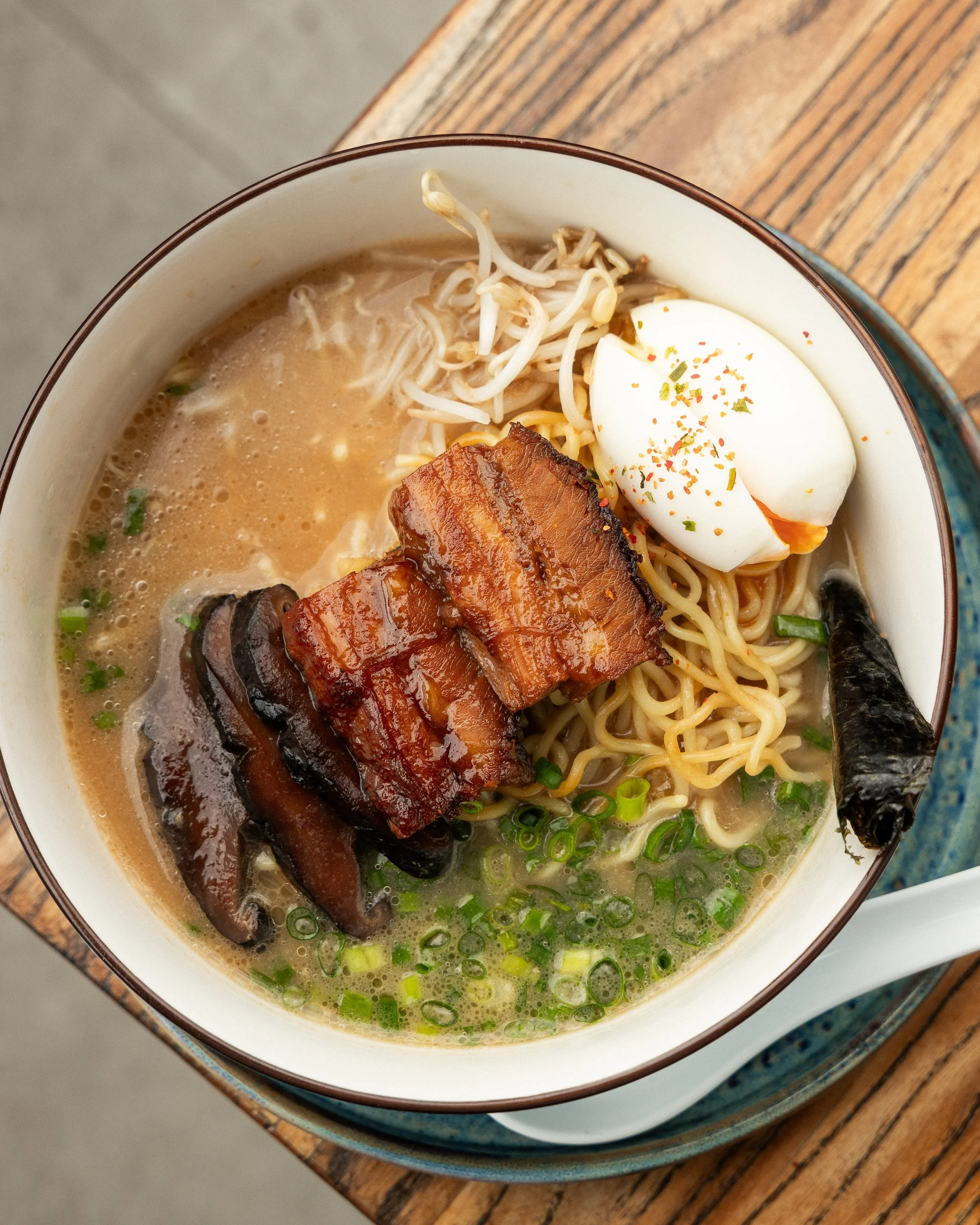 Enkai ramen with sliced pork belly, soft egg, noodles and green onion.