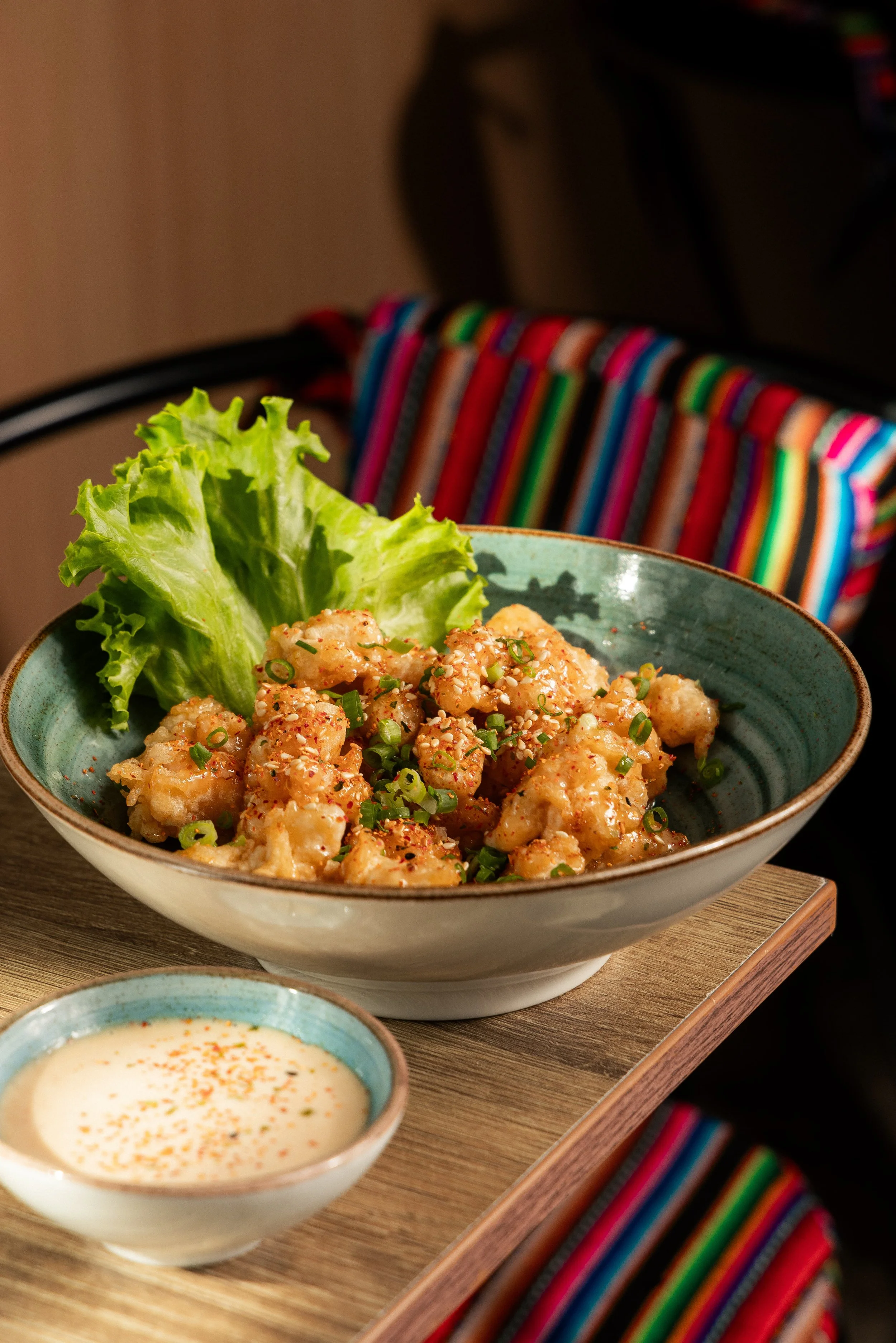 Crispy seafood bites with lettuce, green onion and creamy sauce at Enkai.