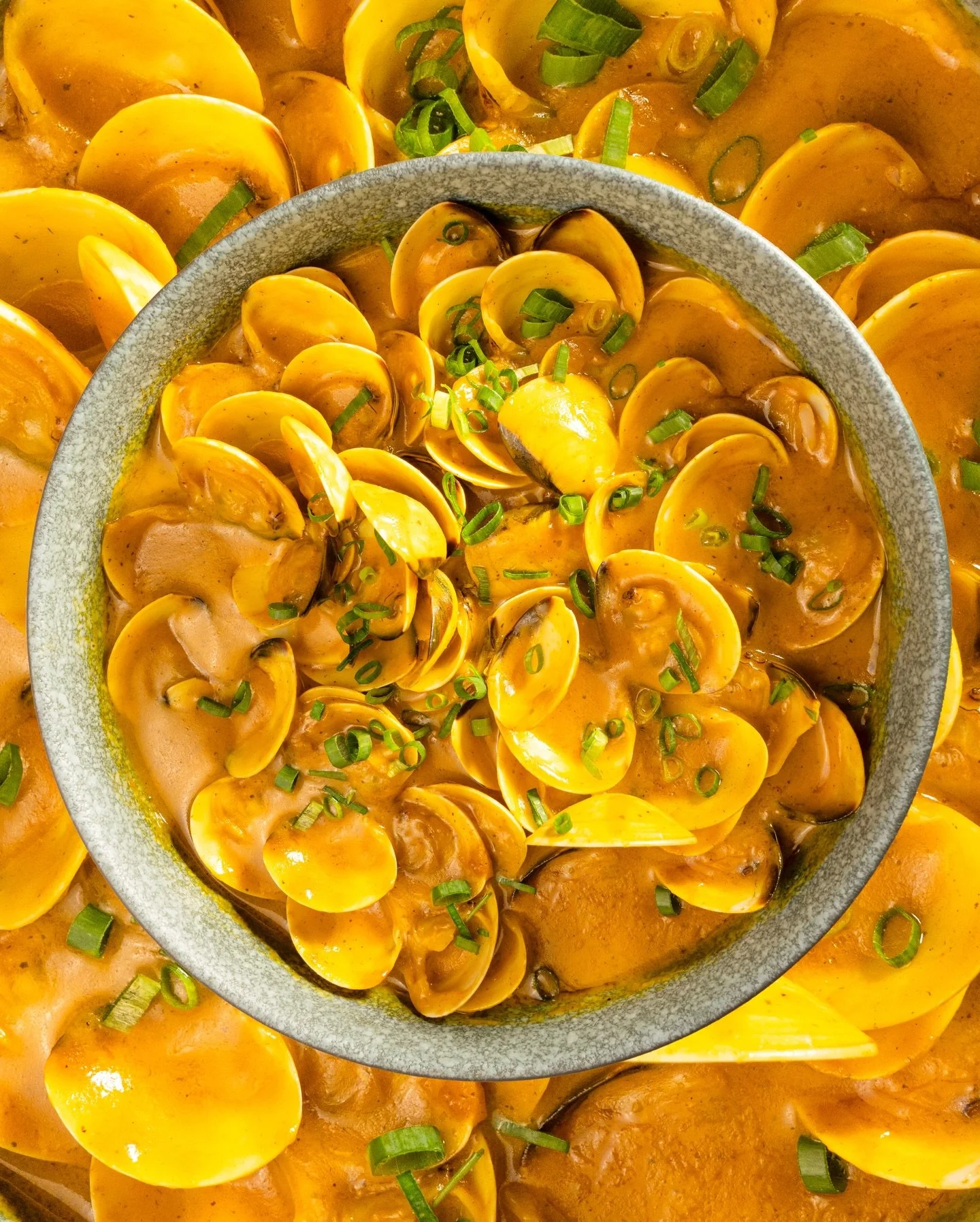 Clams in a rich yellow coconut sauce at La Tapa del Coco