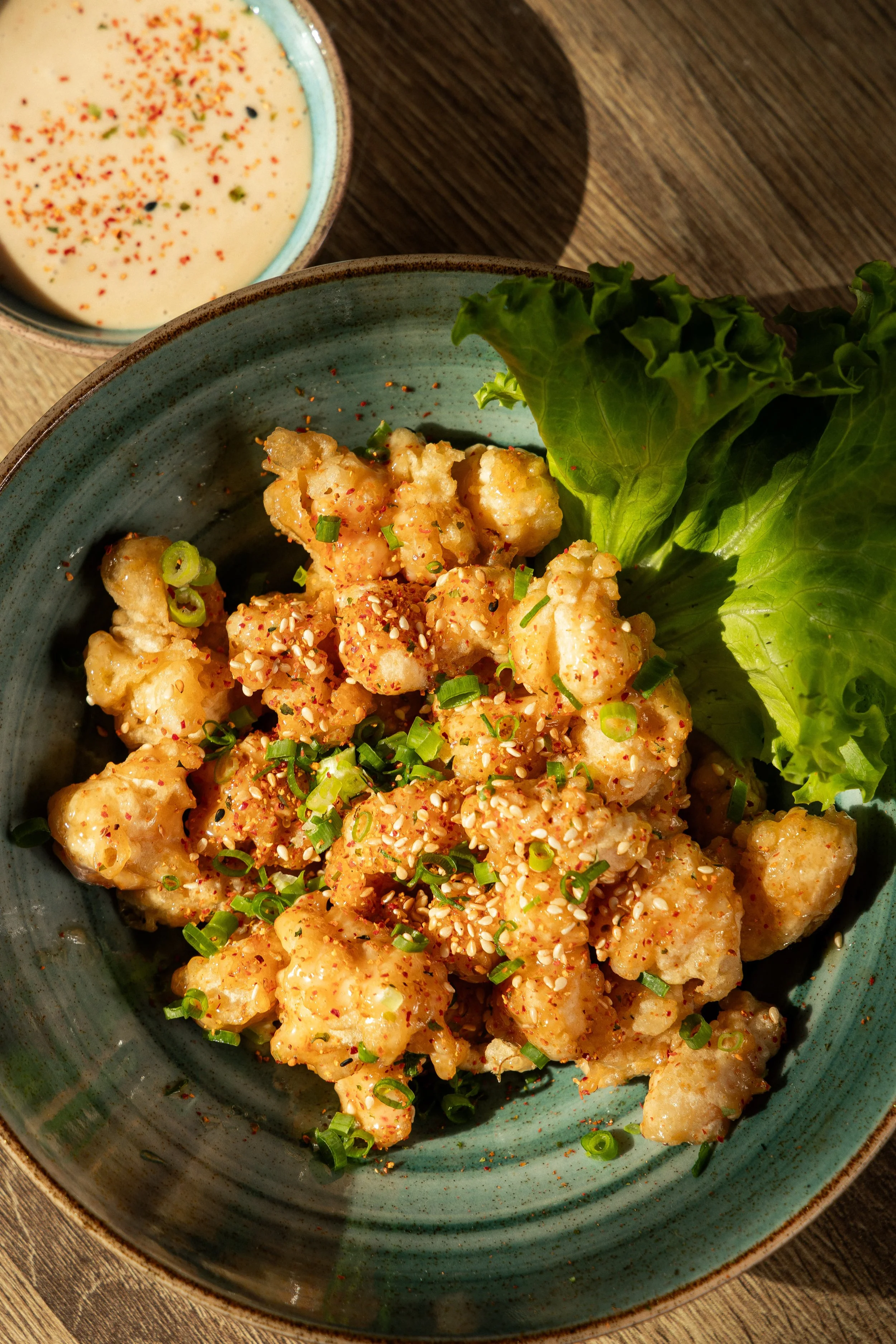 Crispy seafood bites with lettuce, herbs and creamy sauce at Enkai.
