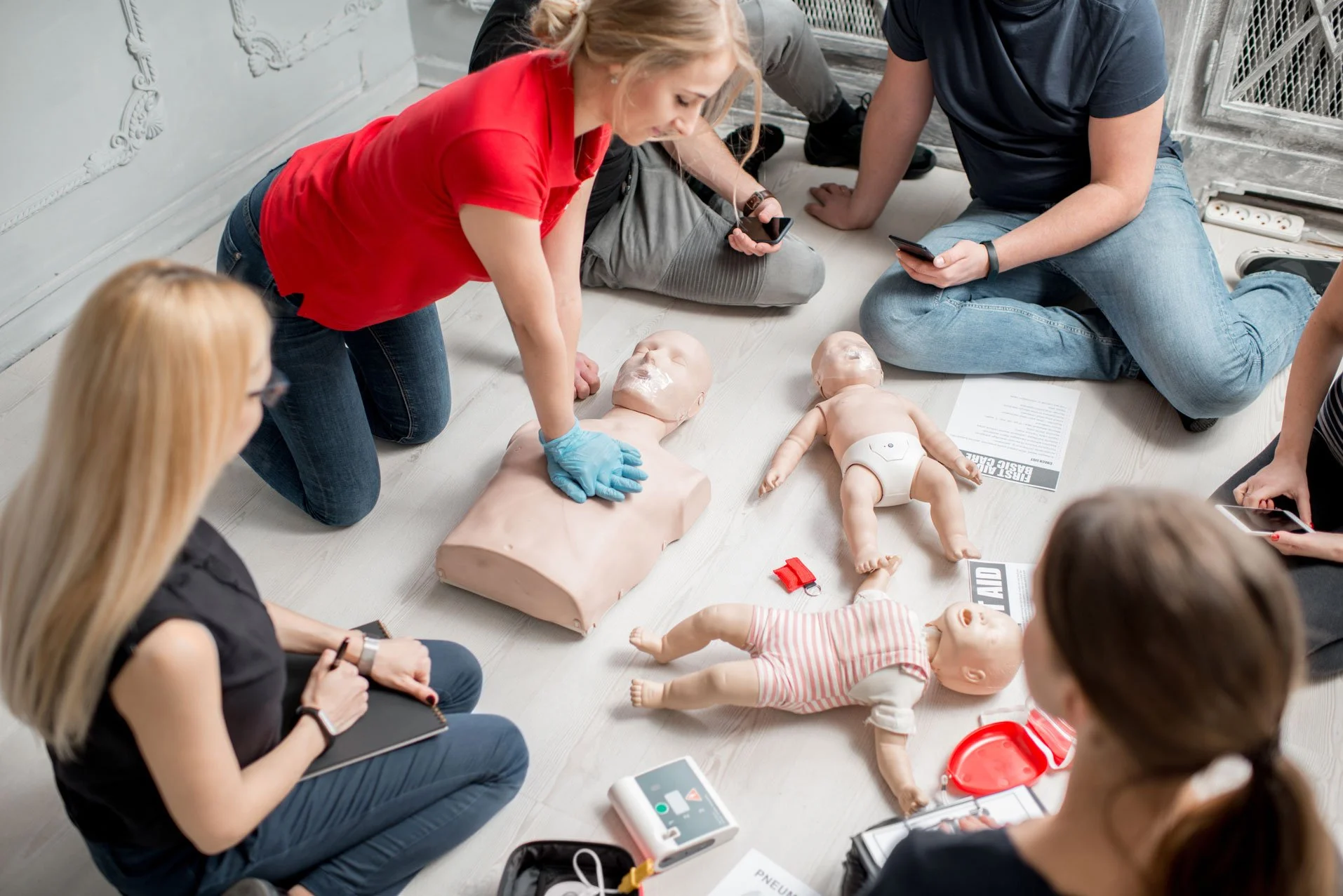 CPR instructor teaching students hands-on training