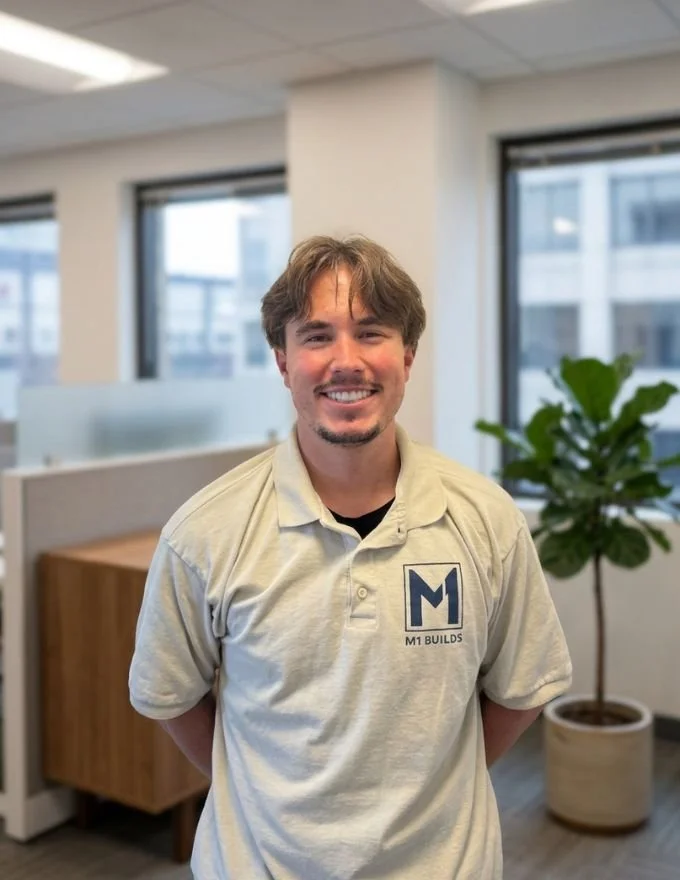 Man, brown hair, goatee, M1 Builds, polo shirt, office, professional, construction, builder