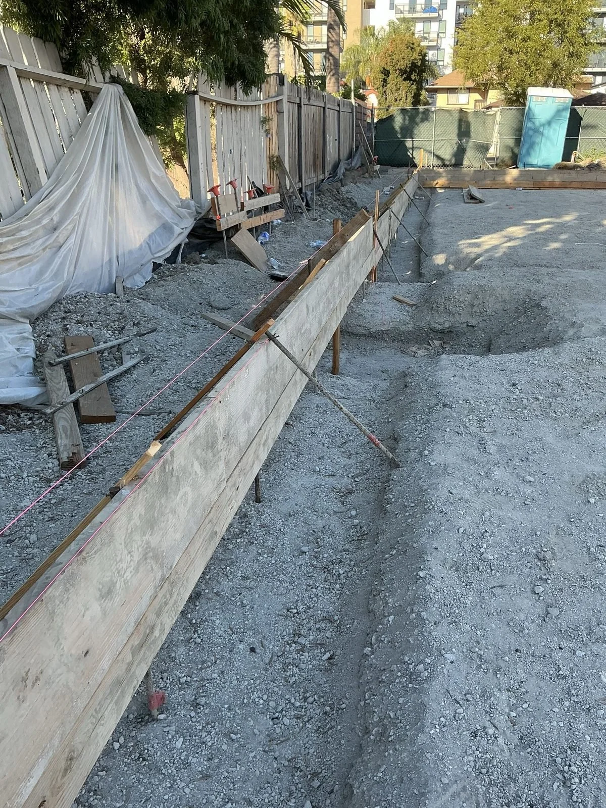 Wood footing forms and trench running along the property line