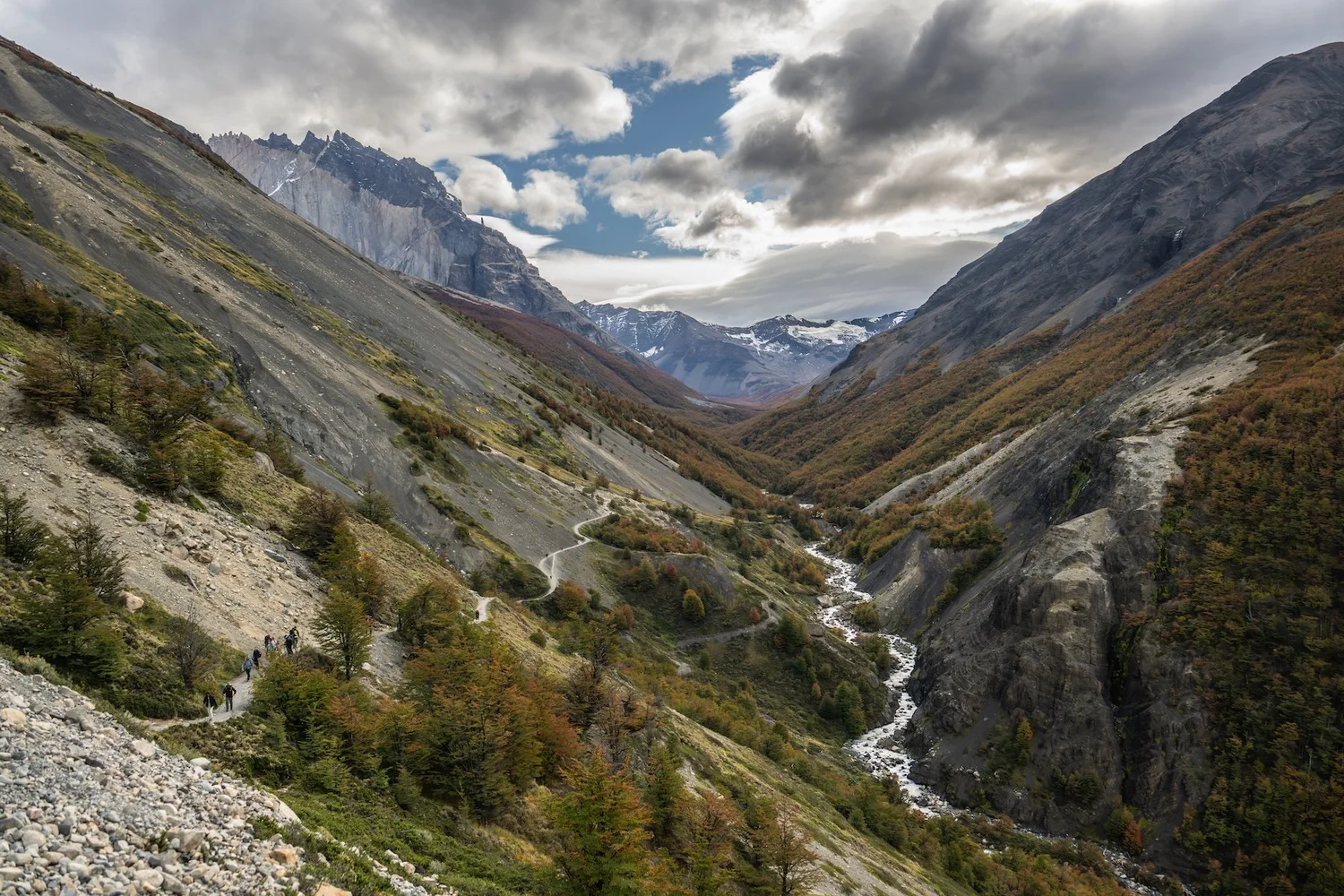 The trail threading up the valley toward the base of the towers