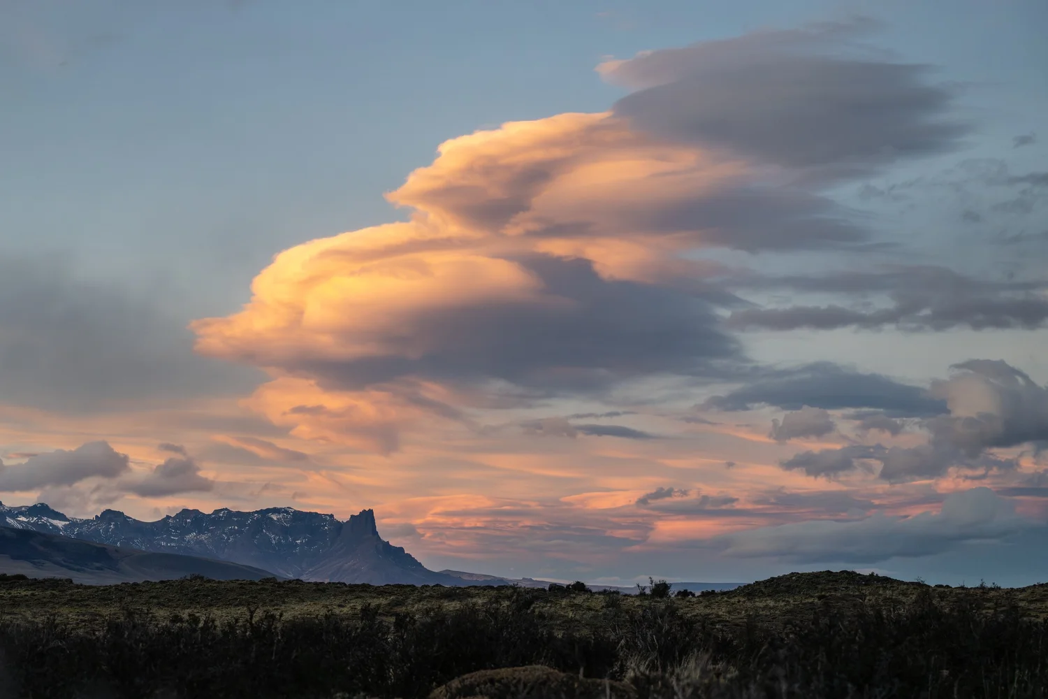 Lenticular clouds over the massif at sunset