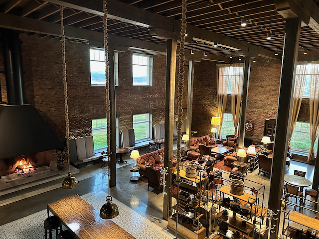 The lounge fireplace under old brick and steel