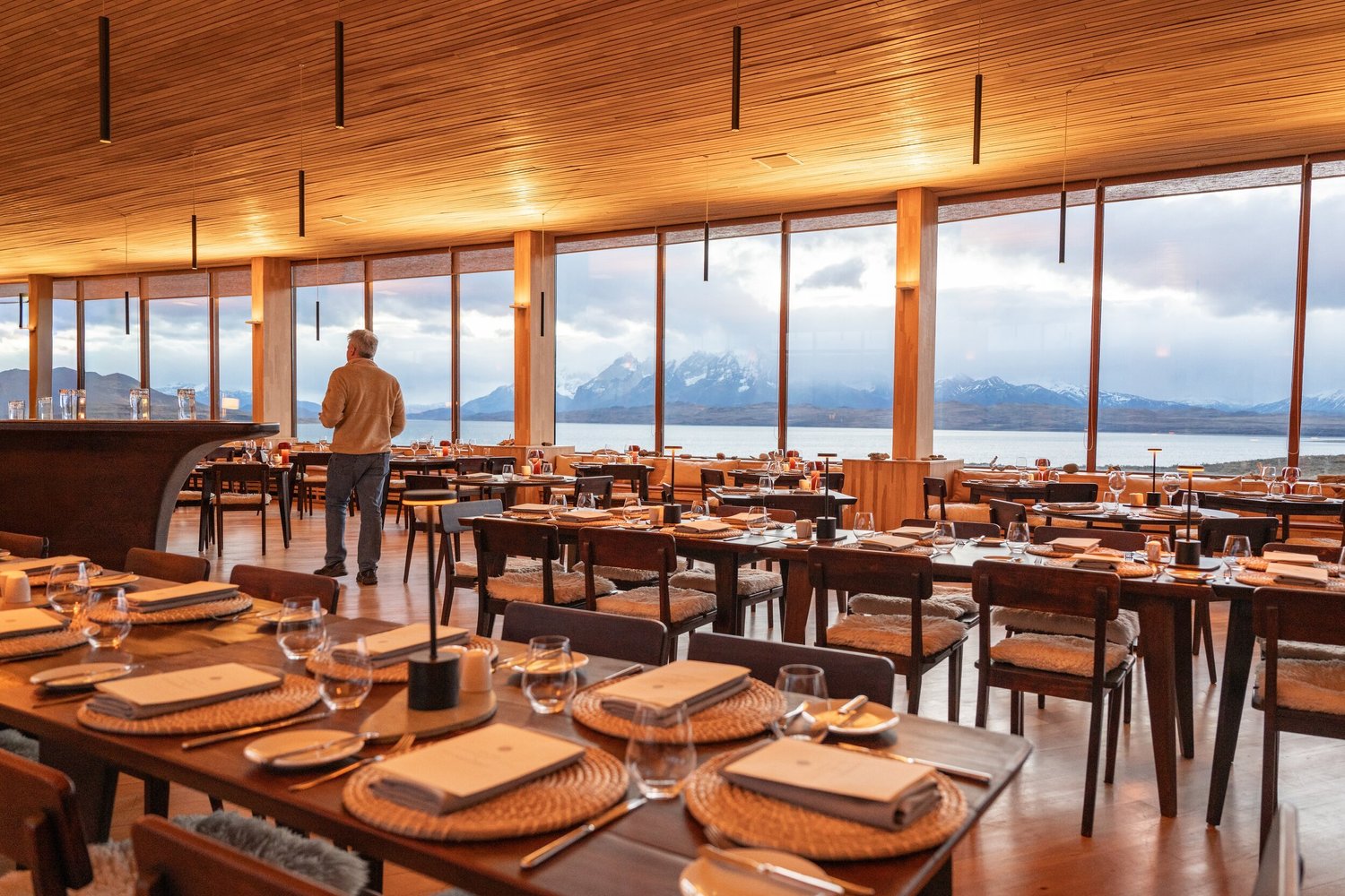 The dining room set for dinner above the lake