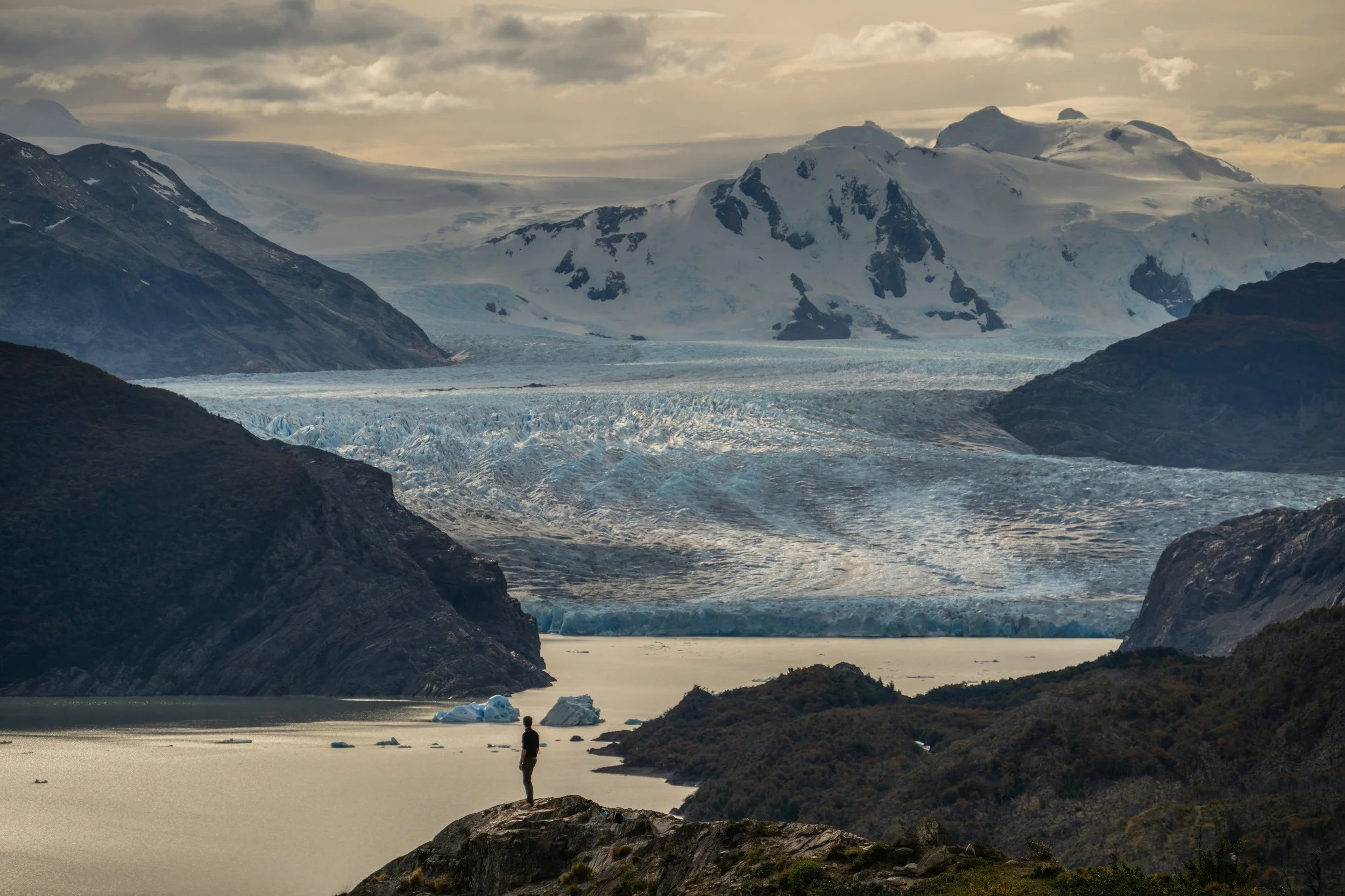 Grey Glacier meeting Grey Lake with a lone figure on the shore