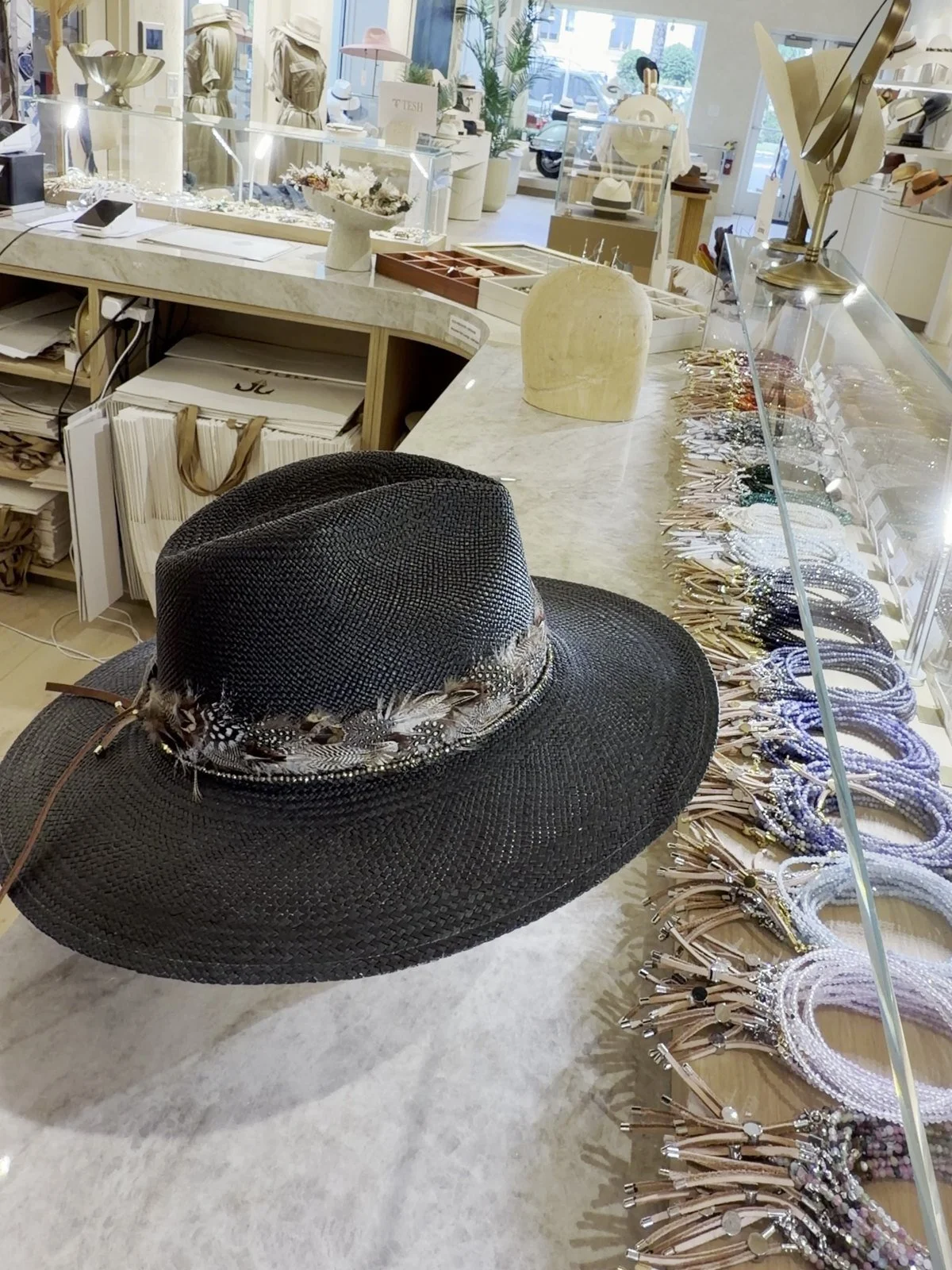 A finished TESH® hat on the embellishment bar, lined with trims
