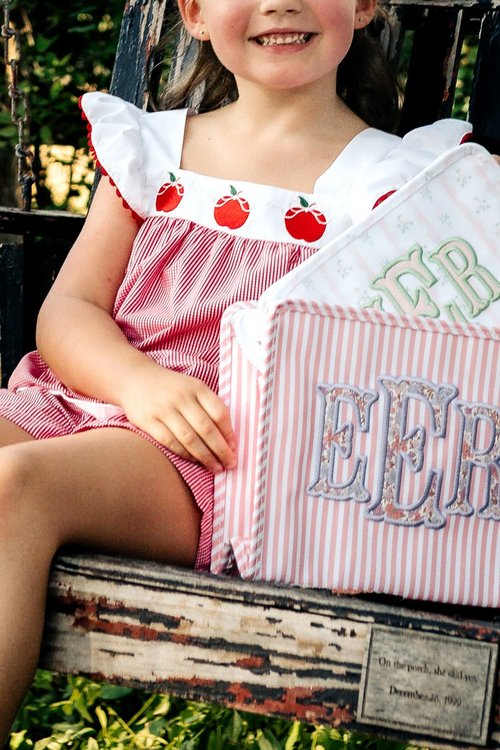 Child holding a monogrammed bag