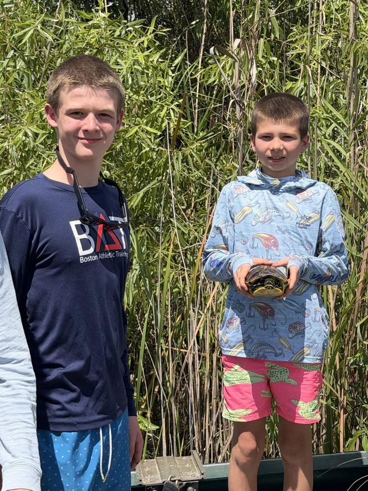 Two guests with a reptile during a Florida outdoor adventure