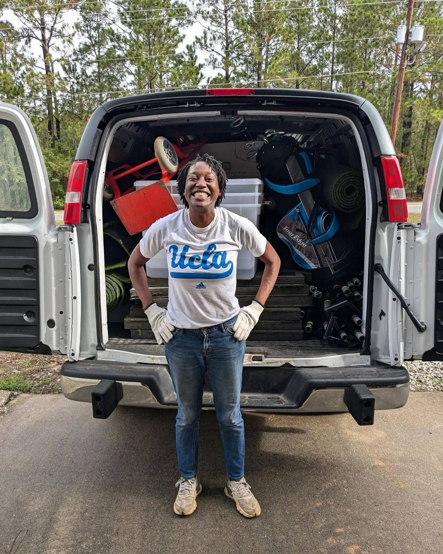 Corinne in front of her van packed with equipment to open Green Office