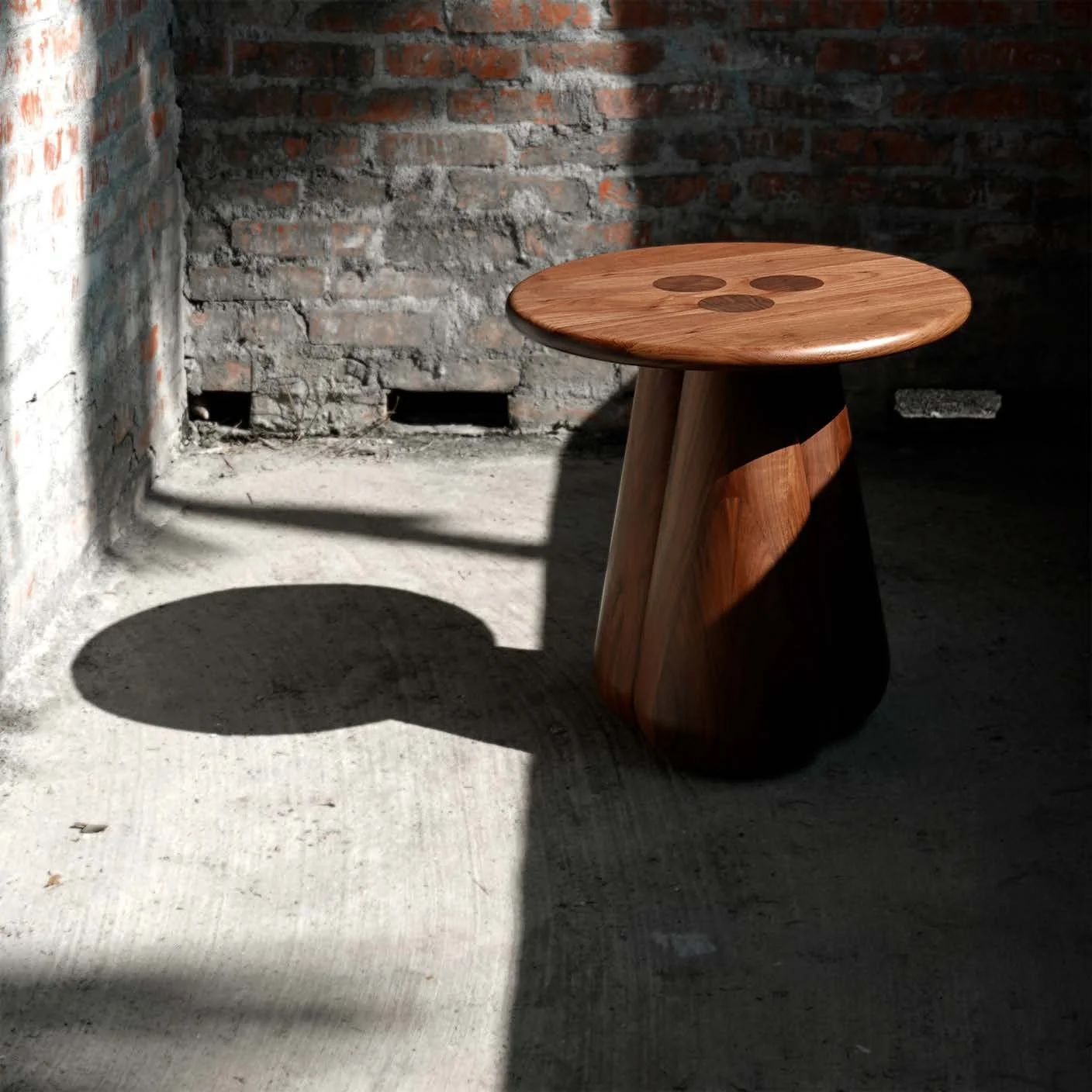 Slash Works Object 01 — walnut version in a sunlit brick room, casting a long shadow