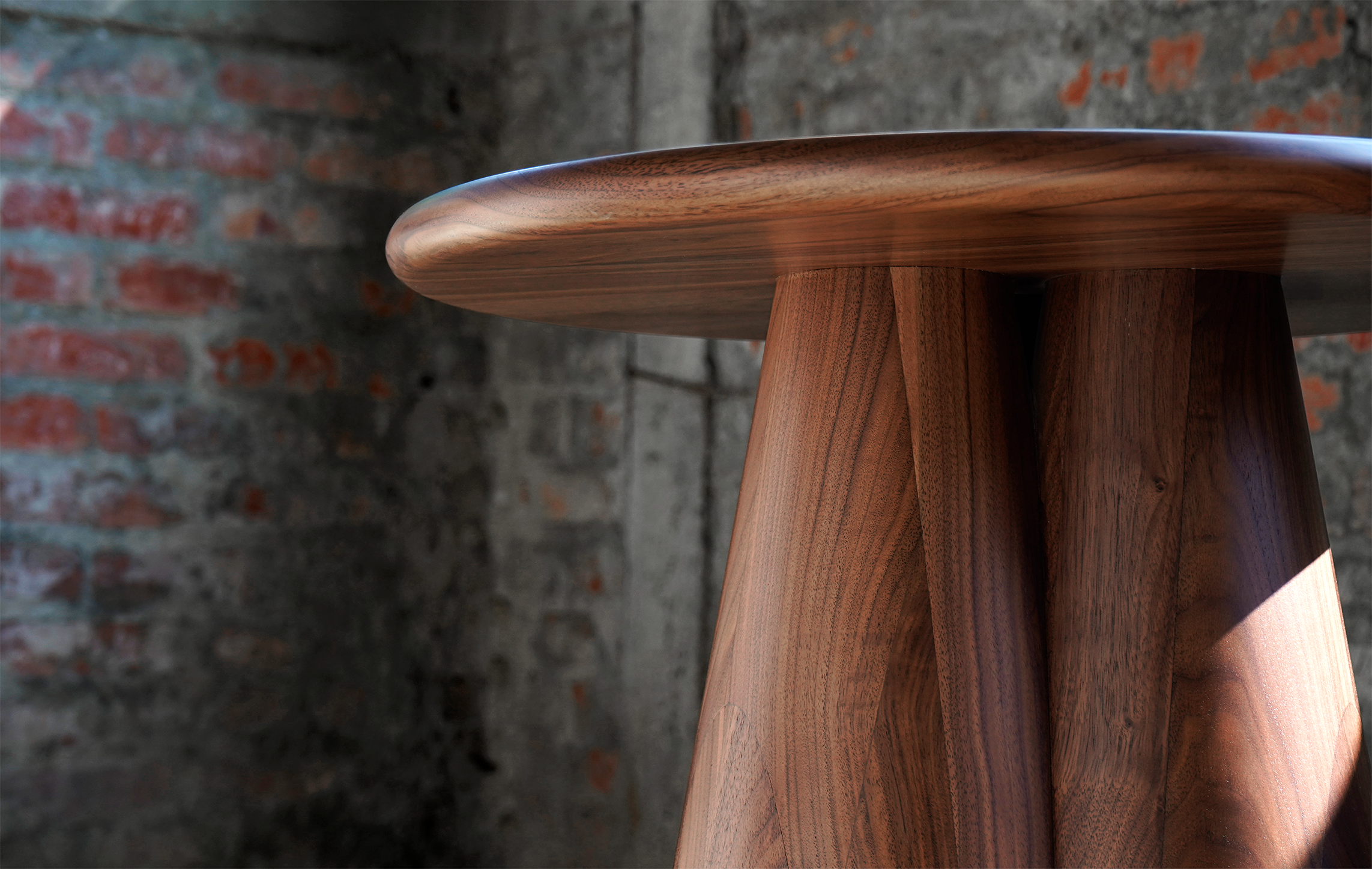 Slash Works Object 01 — walnut top edge and fluted base against a brick wall