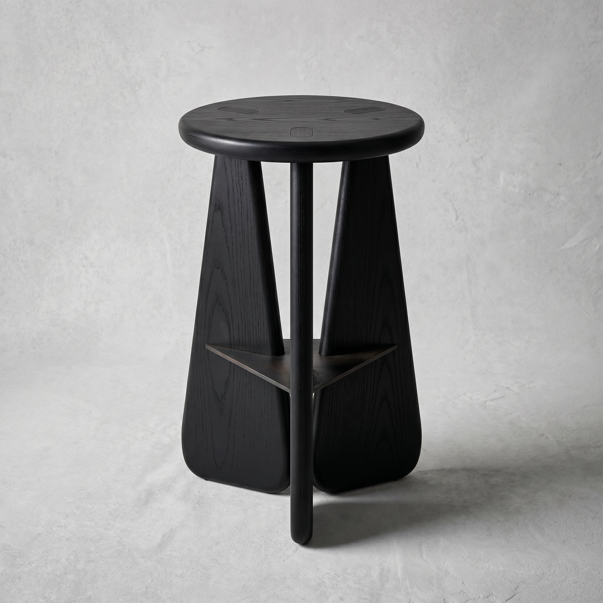 Slash Works Object 02 — black-stained stool on a plaster backdrop, front view