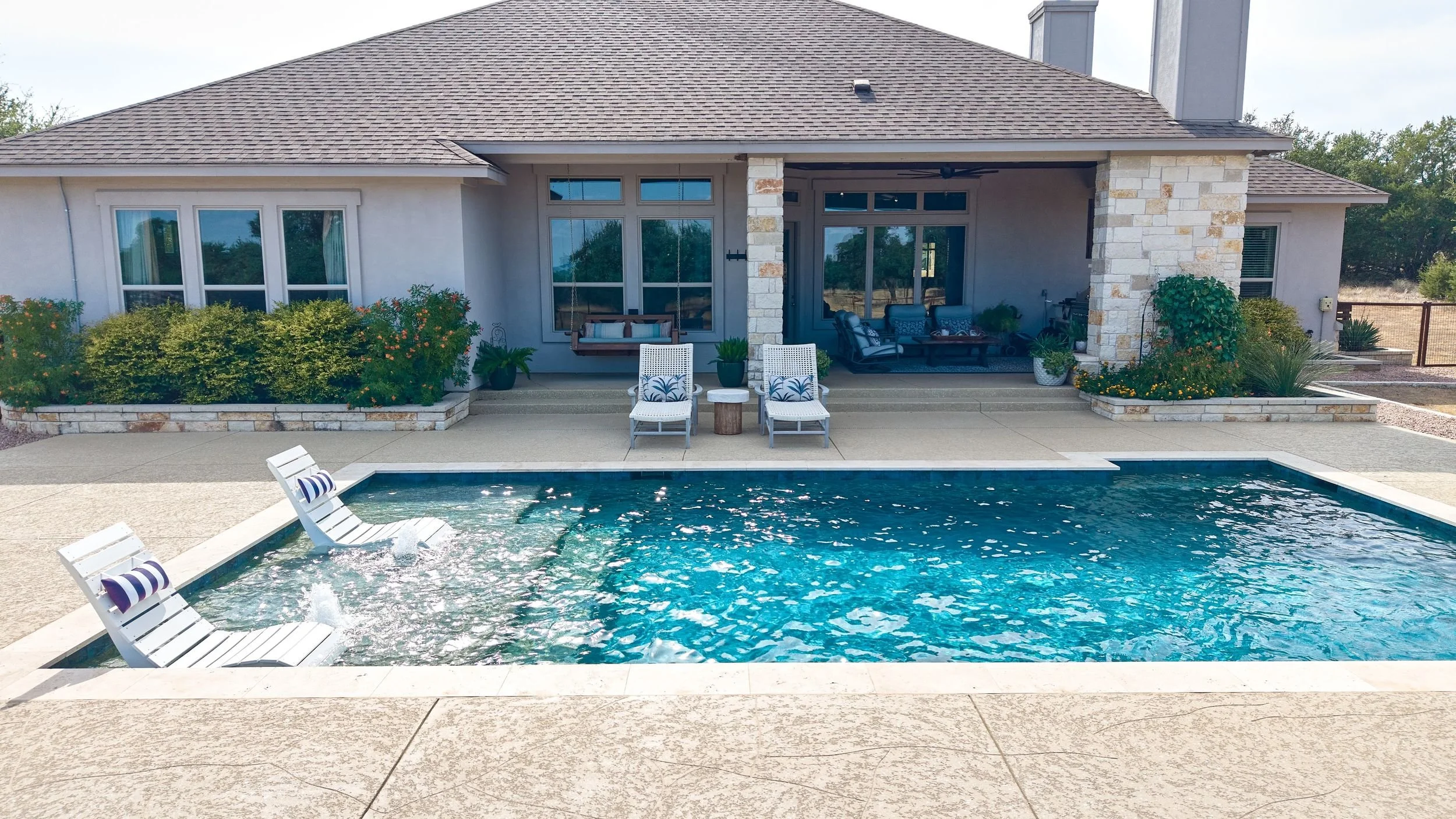 Poolside lounge area — Spicewood custom pool build